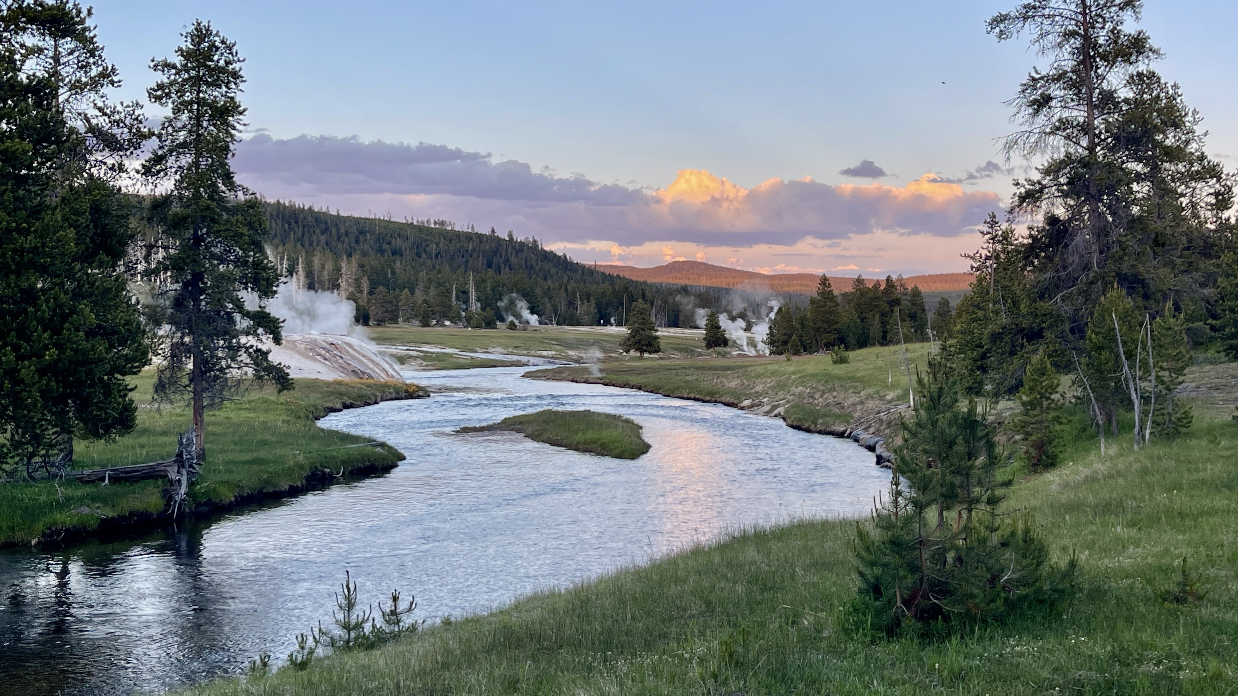 An orange and black off-road vehicle on rocks.