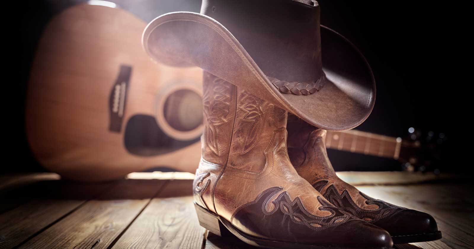 Crowd raising hands with rock and metal horns at an outdoor music festival.