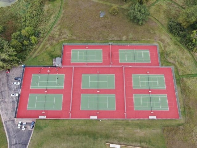 Resurfaced tennis court offering improved traction and visual appeal.