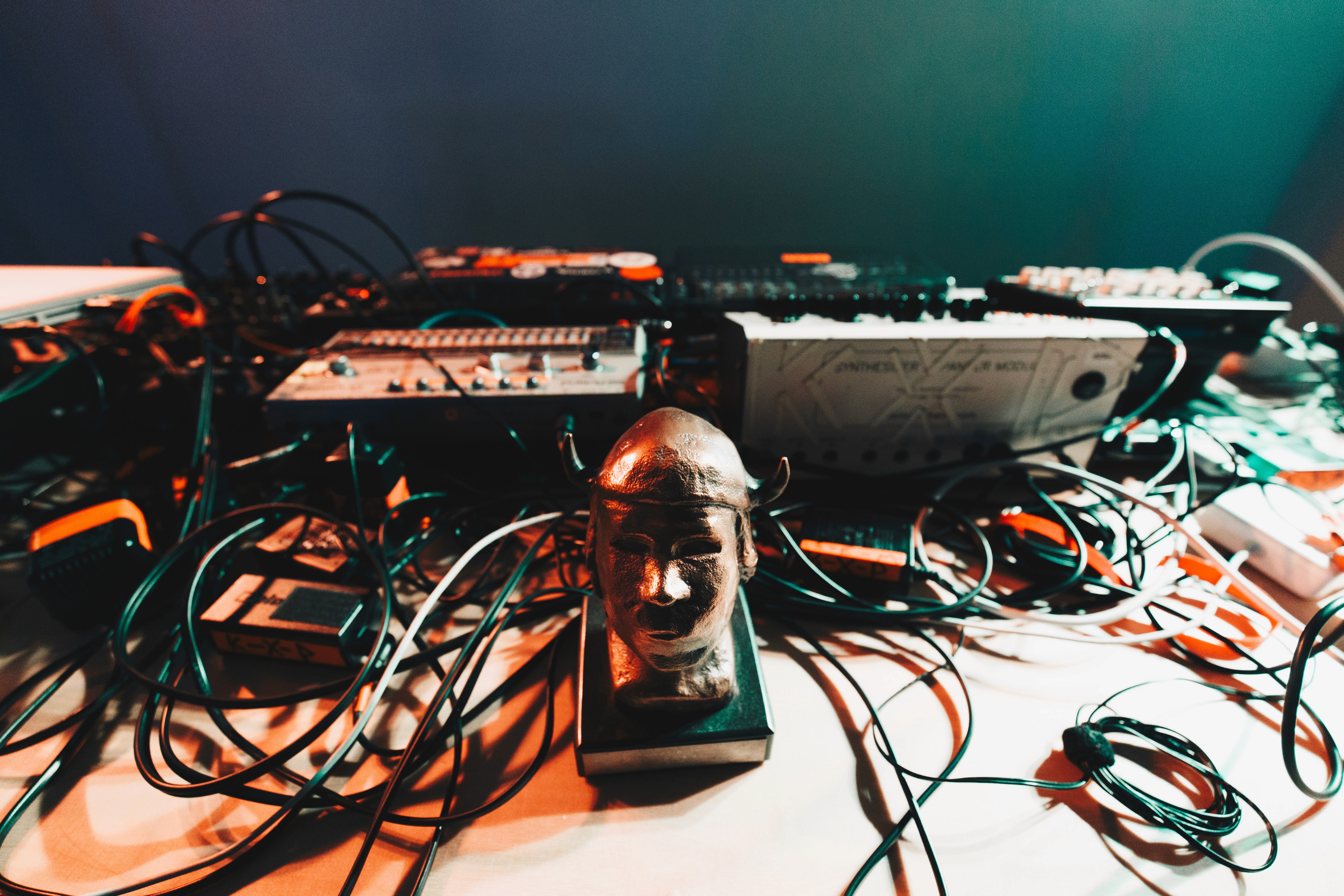 Black and white image of people working at a table with laptops, showing hands gesturing during discussion of digital content displayed on screens, with fabrica® logo in the corner.