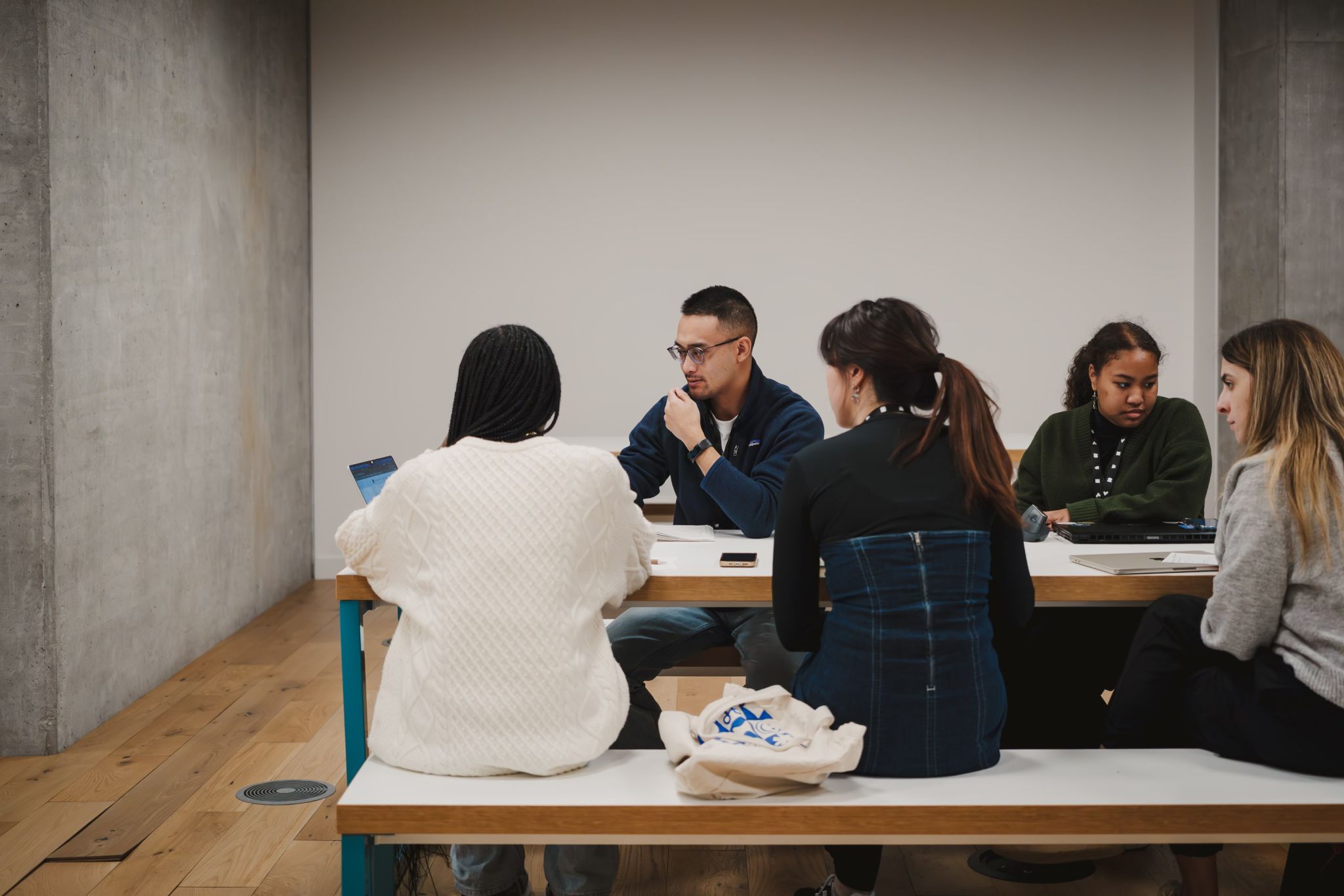 Ellixs reviewing portfolios at Friends of Figma Toronto with a group of other designers