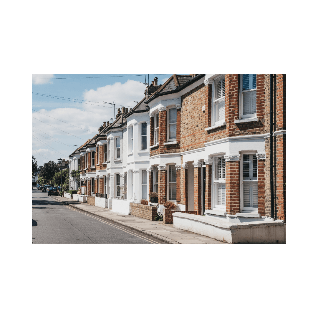 Modern indoor space with large glass doors, lush greenery, and a cozy seating area visible beyond.