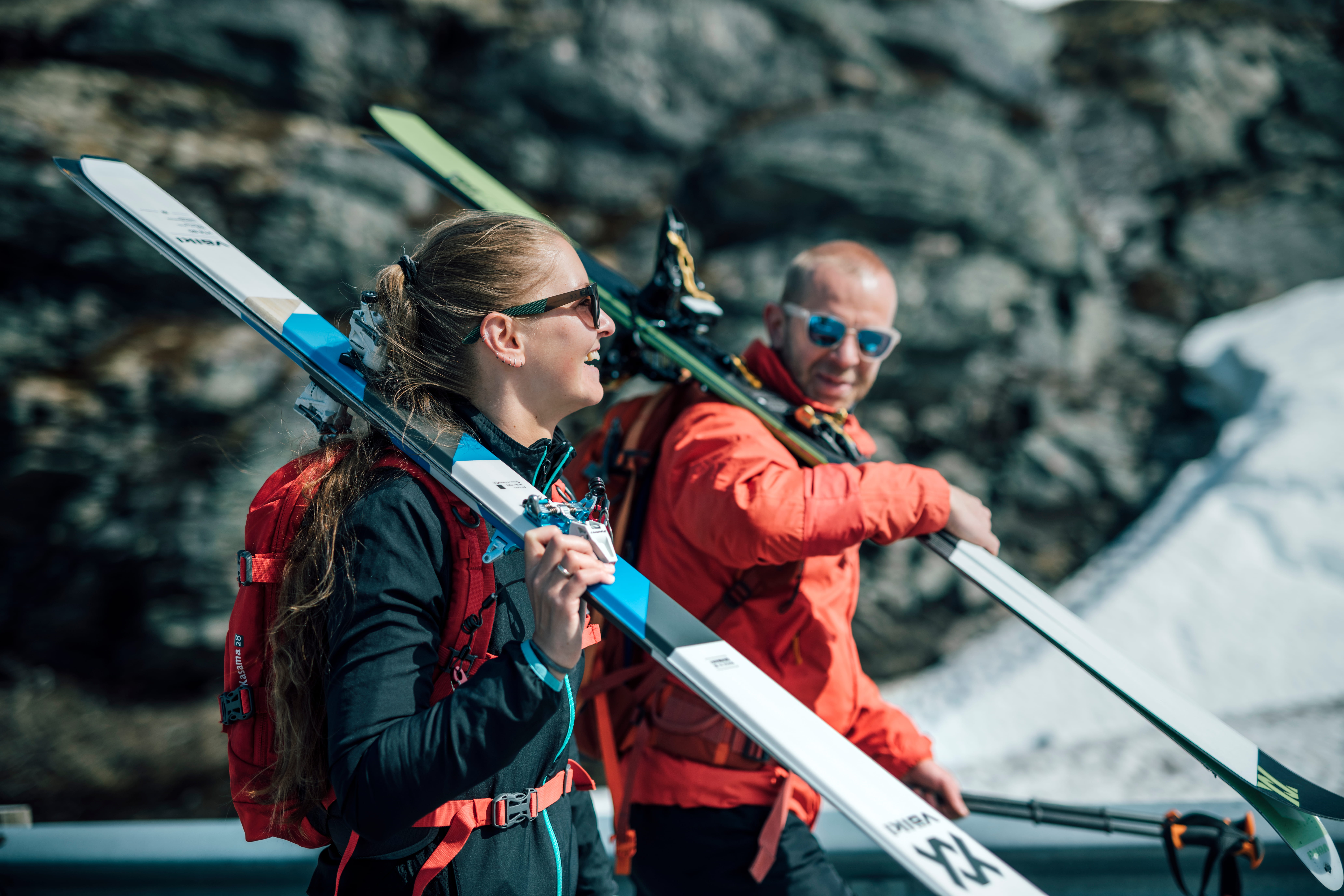 Three children smiling and enjoying a pool, with modern buildings reflecting in the water behind them.