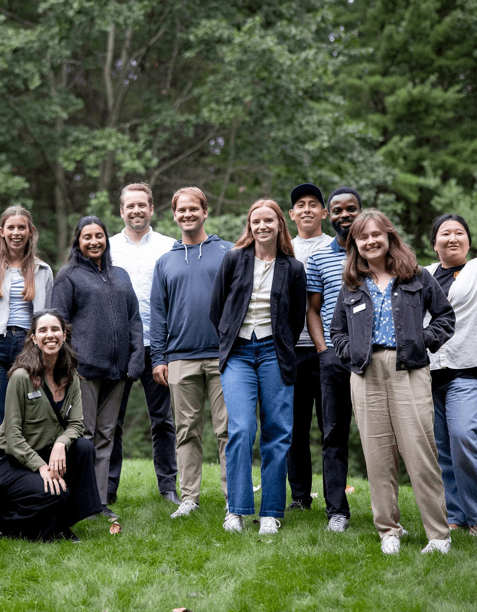 group of students pose in front of trees