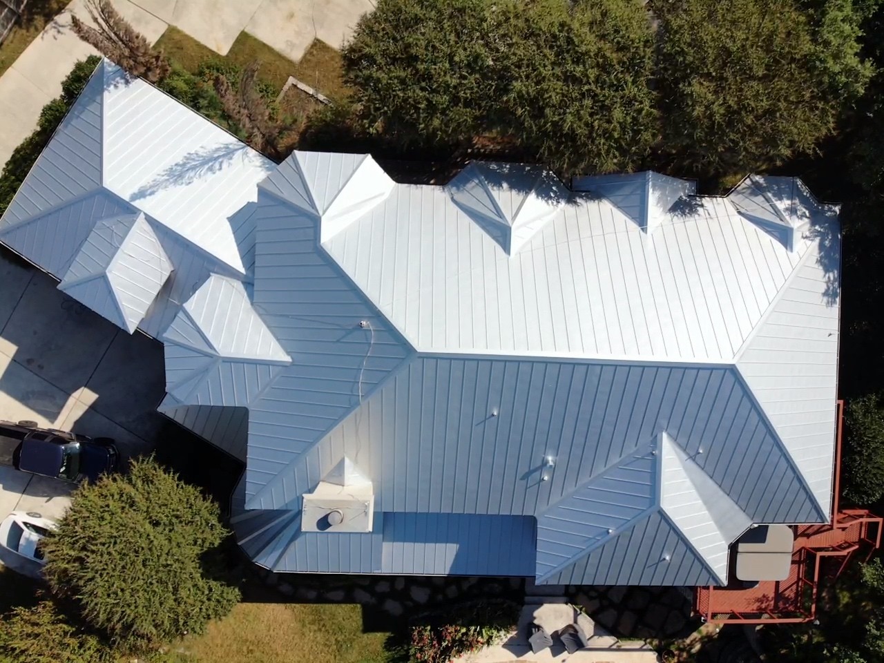 A sleek standing seam 24-gauge mill finish galvalume roof with clean lines and a durable, energy efficient reflective finish.