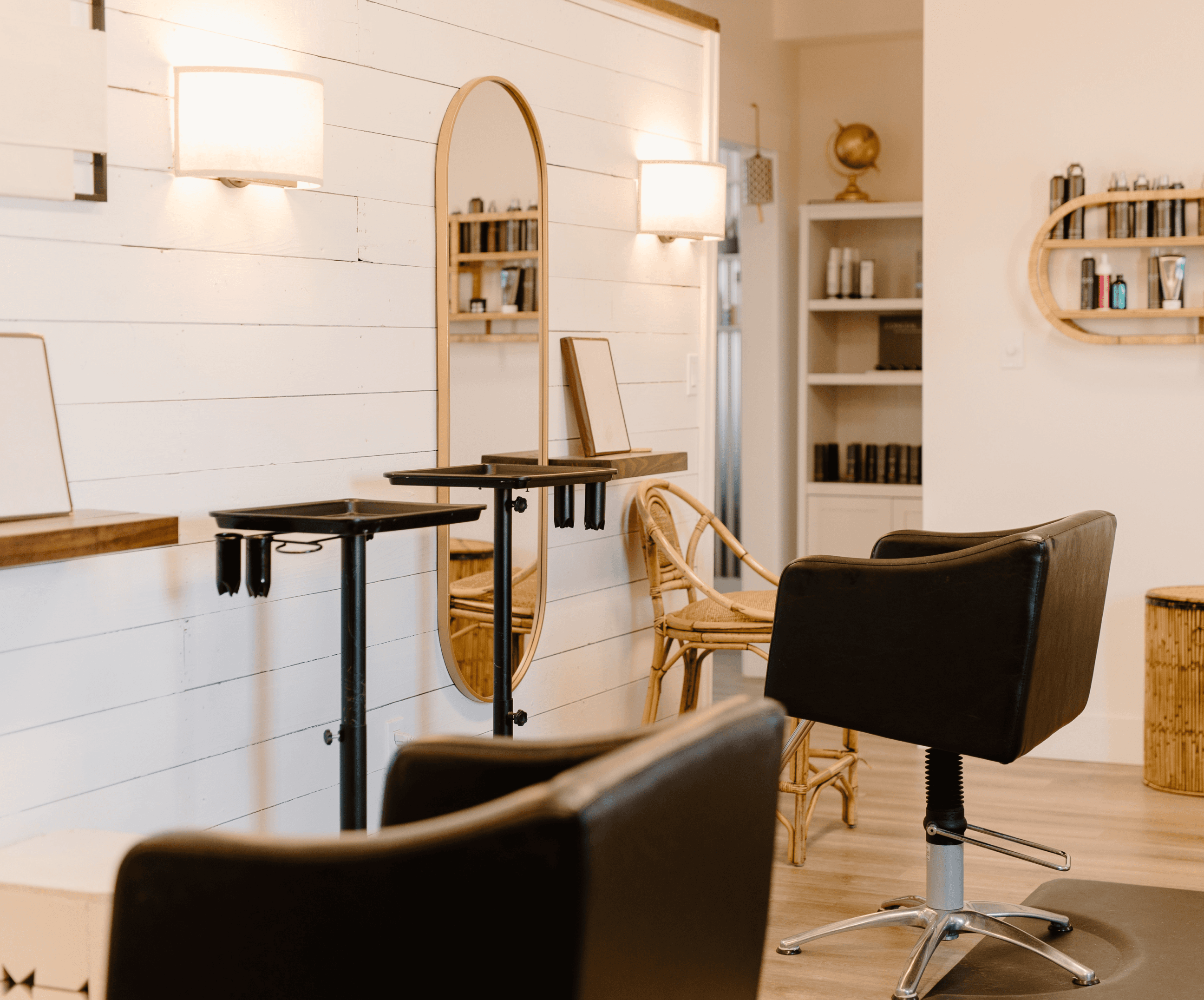 The photo displays the interior of the beauty salon. Two chairs for clients. The interior is in pleasant brown tones.