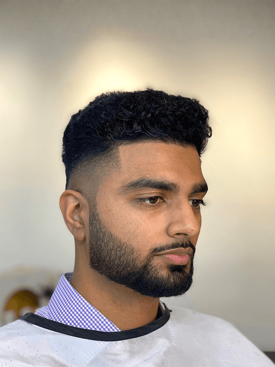 shallow focus photo of man holding scissors