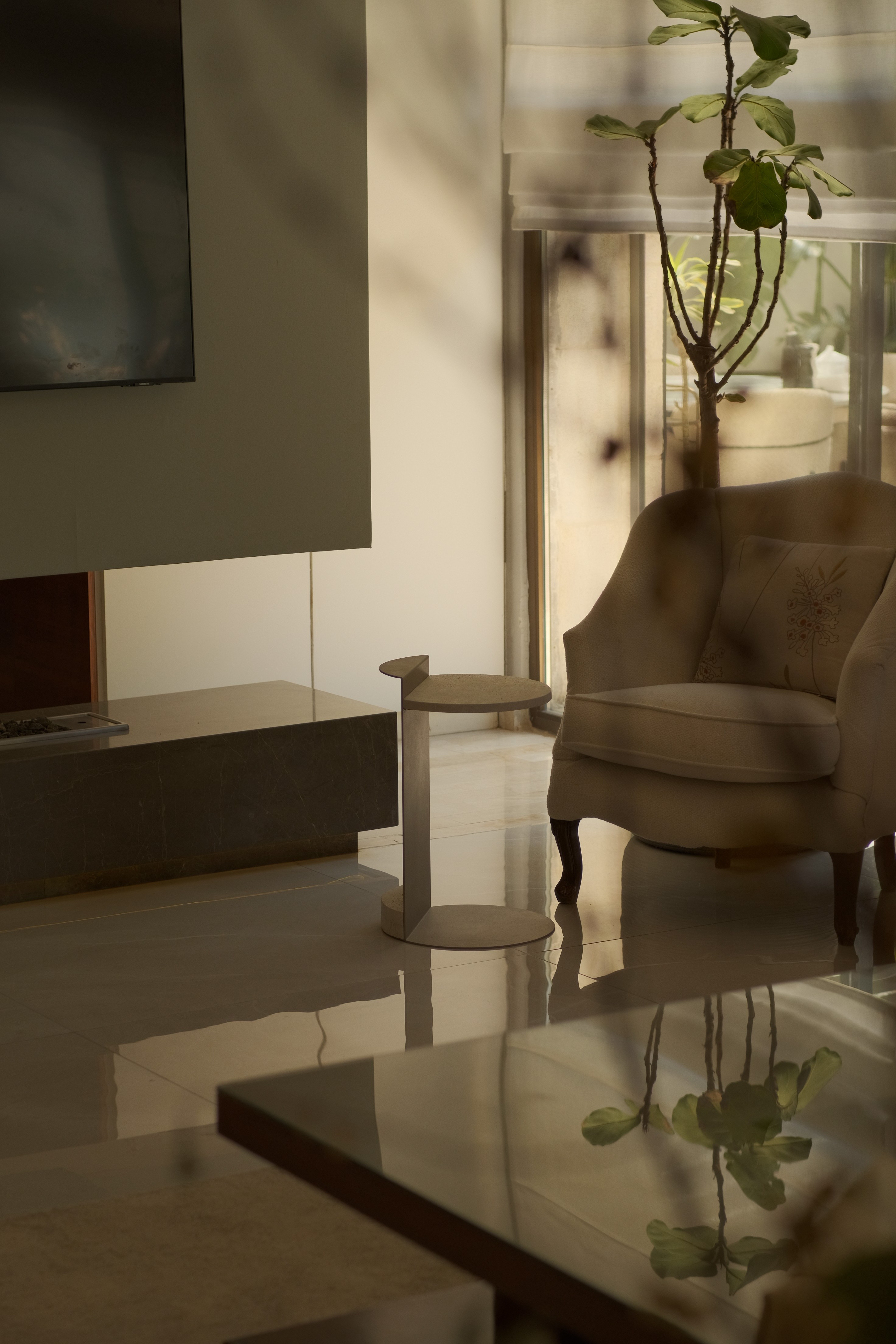 A moody scene of a room with a lamp shade