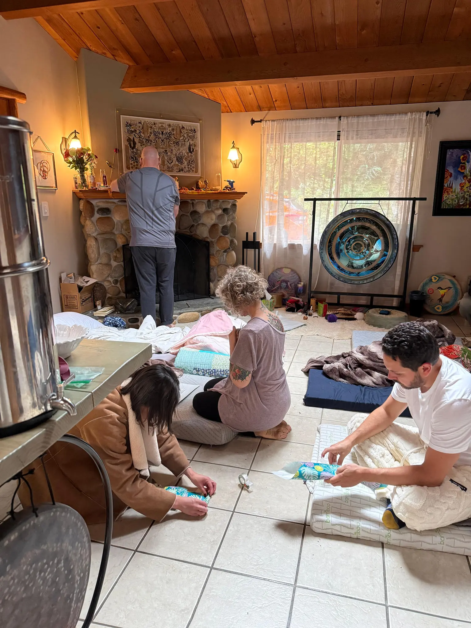 Group of participants in an indoor ceremony space with gong and ceremonial altar for solstice retreat