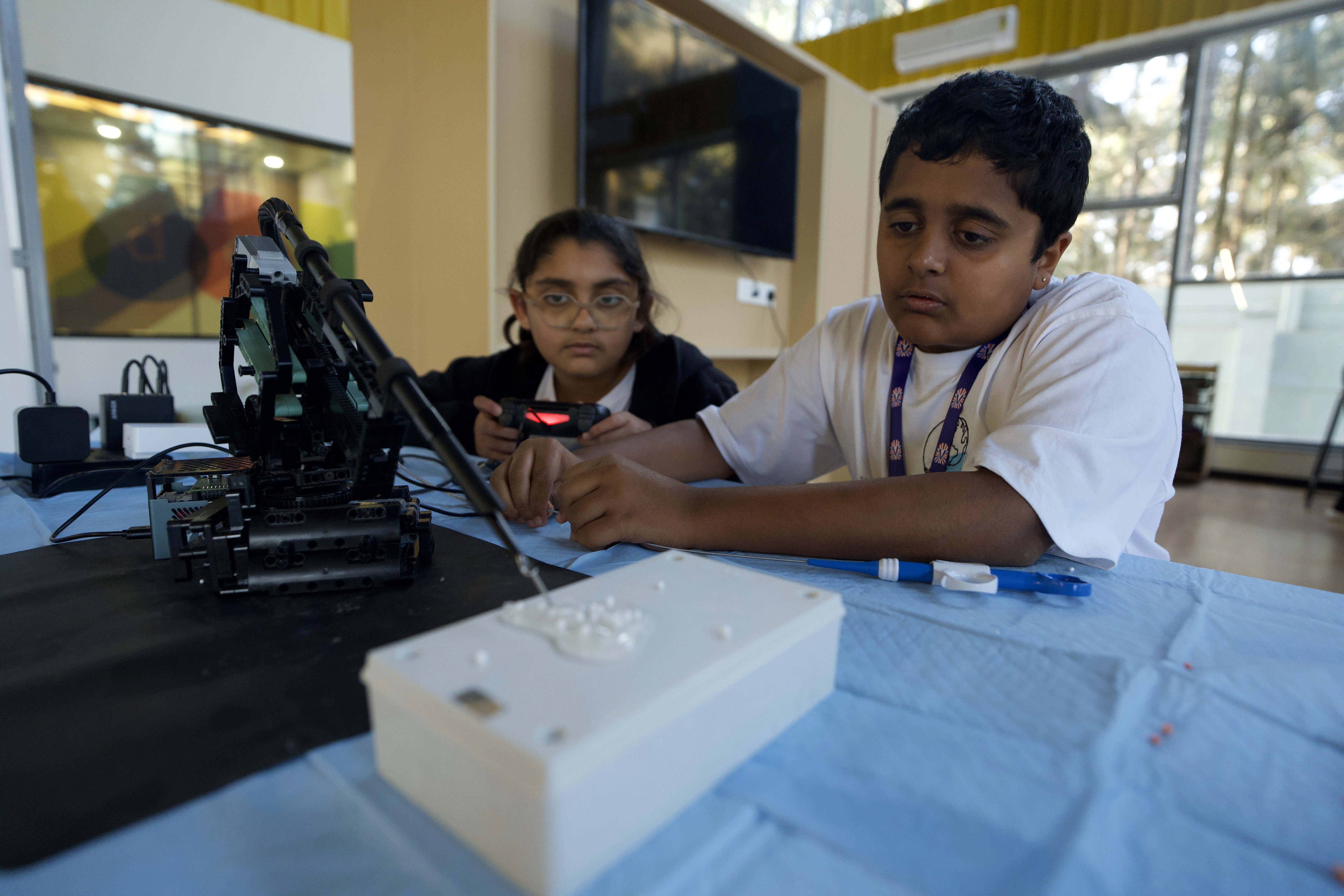 Students assemble a robot boosting their critical thinking skills
