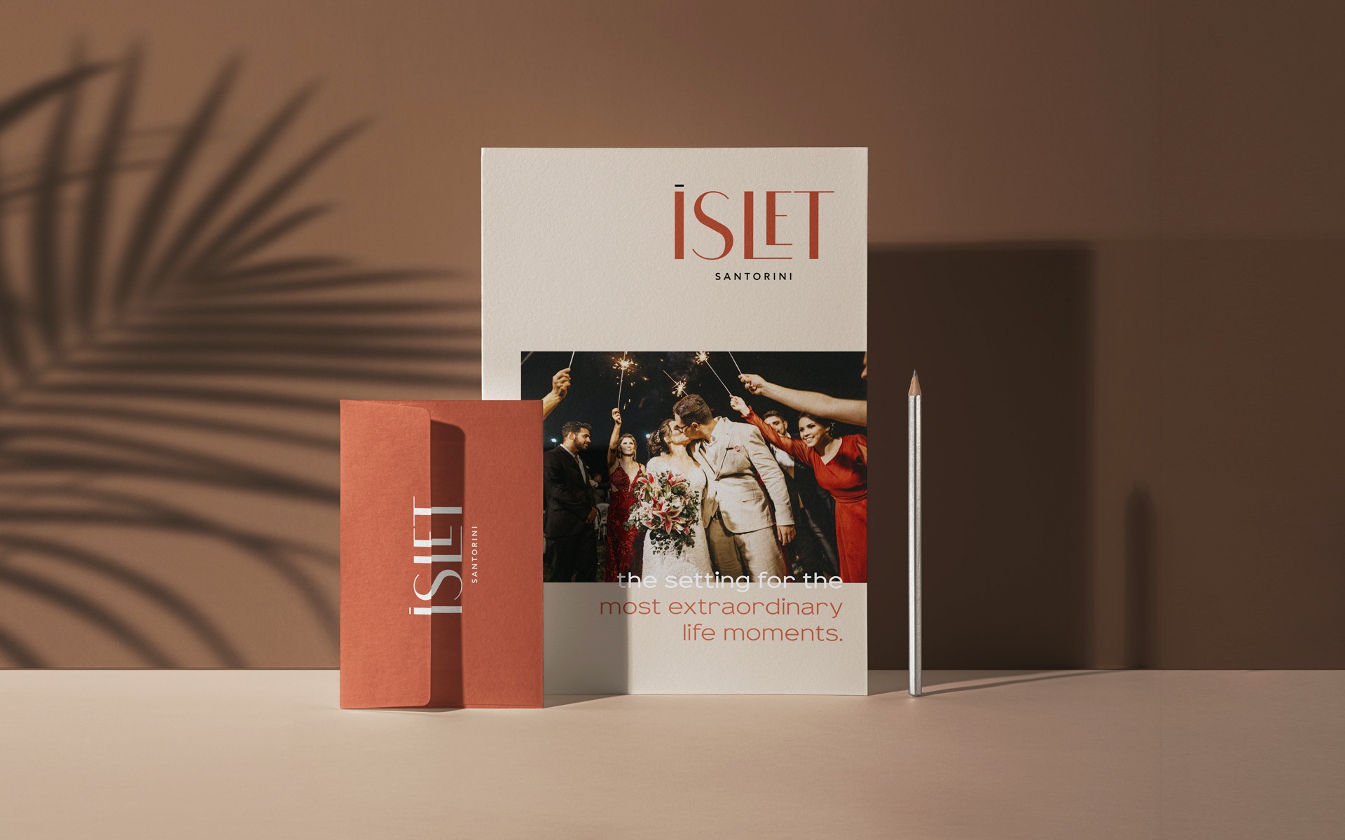 Application of the ISLET Santorini identity on printed promotional material, using a warm color palette and focusing on the hospitality experience
