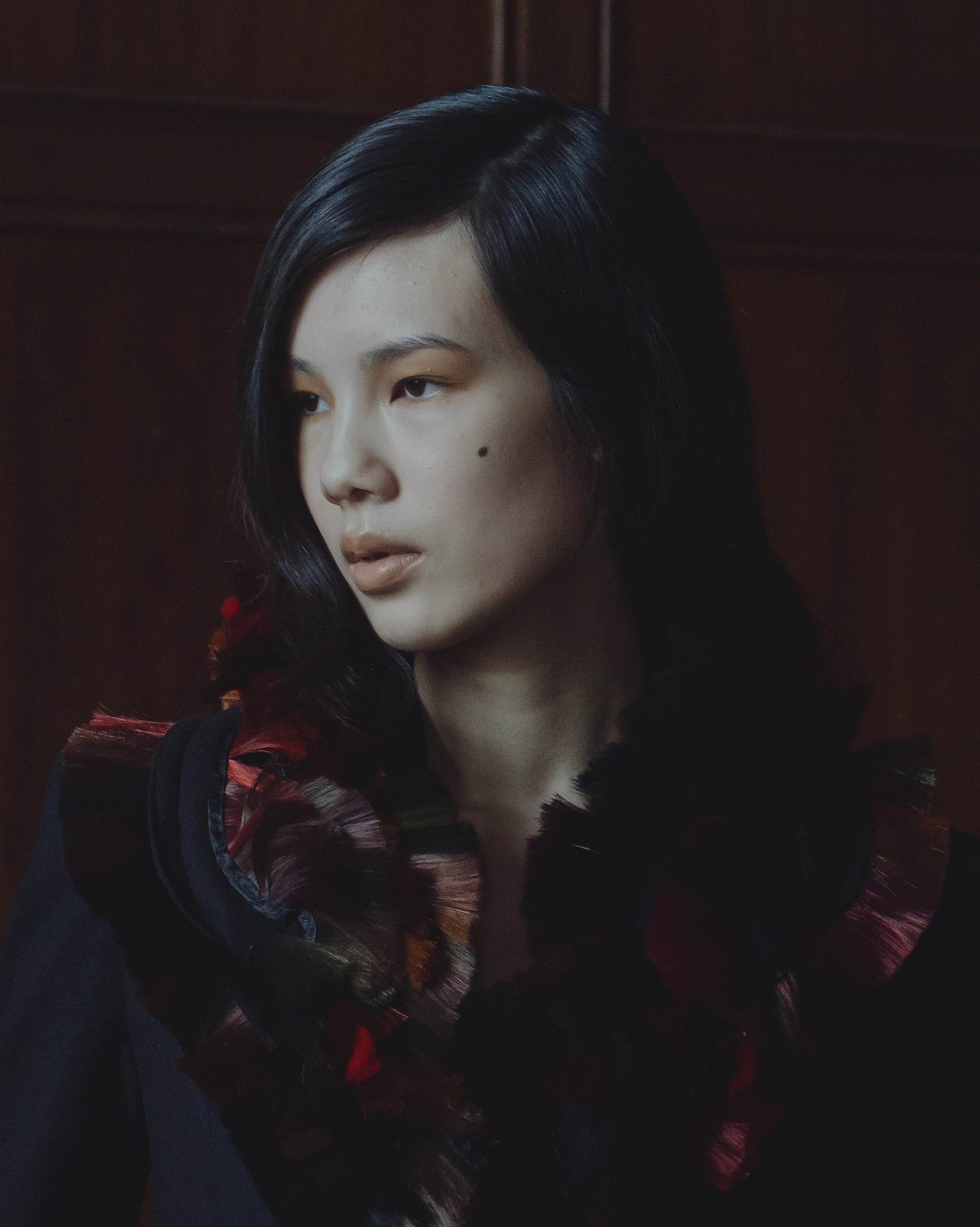 Profile of a model wearing a ringed collar
