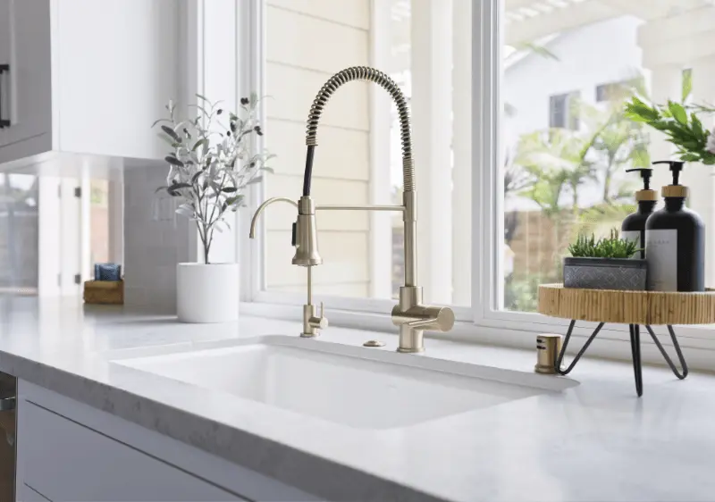 Close-up shot of the kitchen sink and faucet, detailing the design and fixtures in the Dana Point Remodel. Photo by Todd Huge.