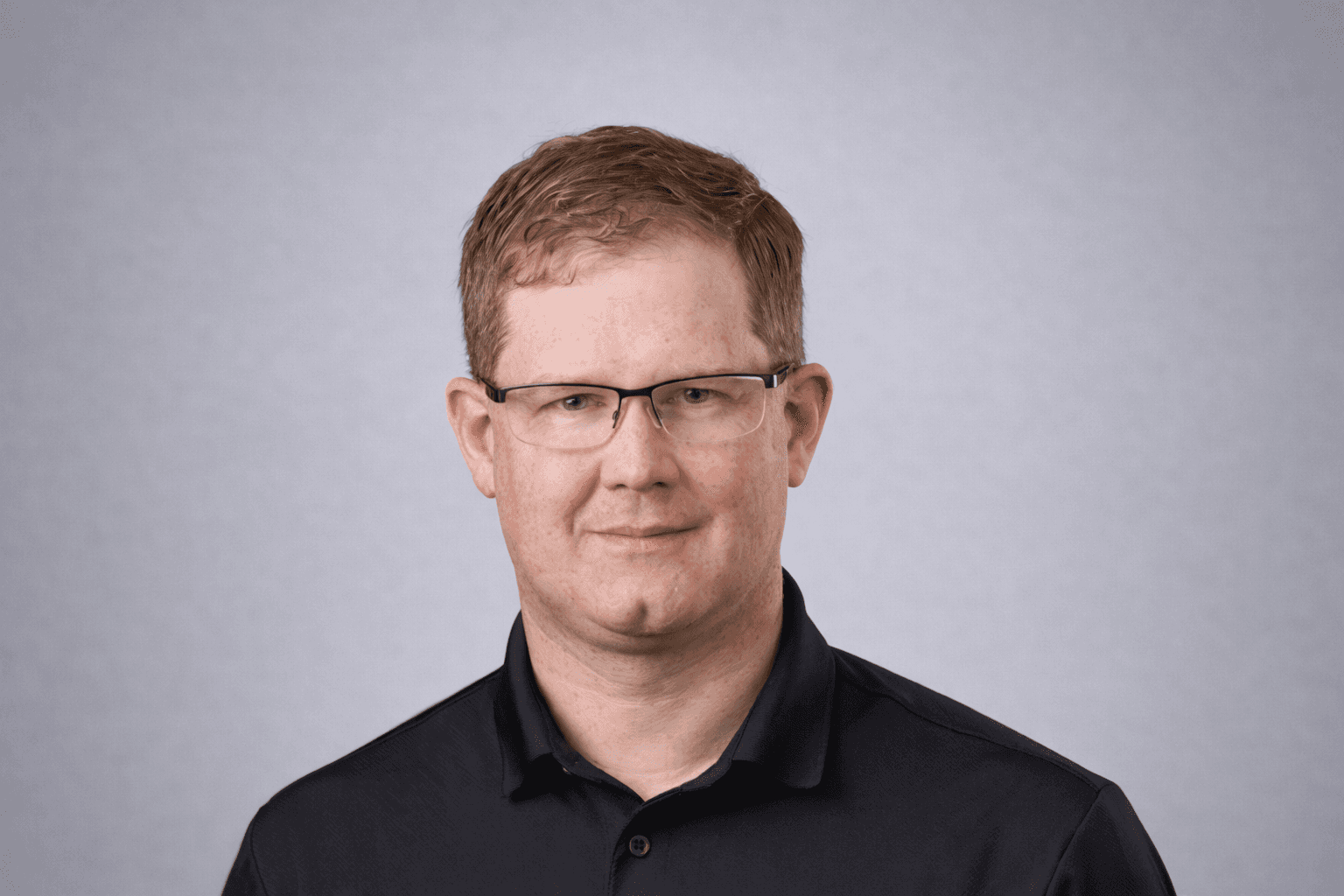 Black and white portrait of a smiling person with curly hair