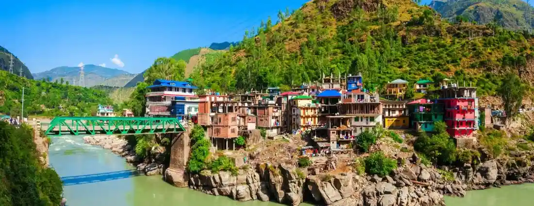 <img src="temple.jpg" alt="Green Mountains in the very green place of uttarakhand where as homes of local located in the right side with a bridge on left." />