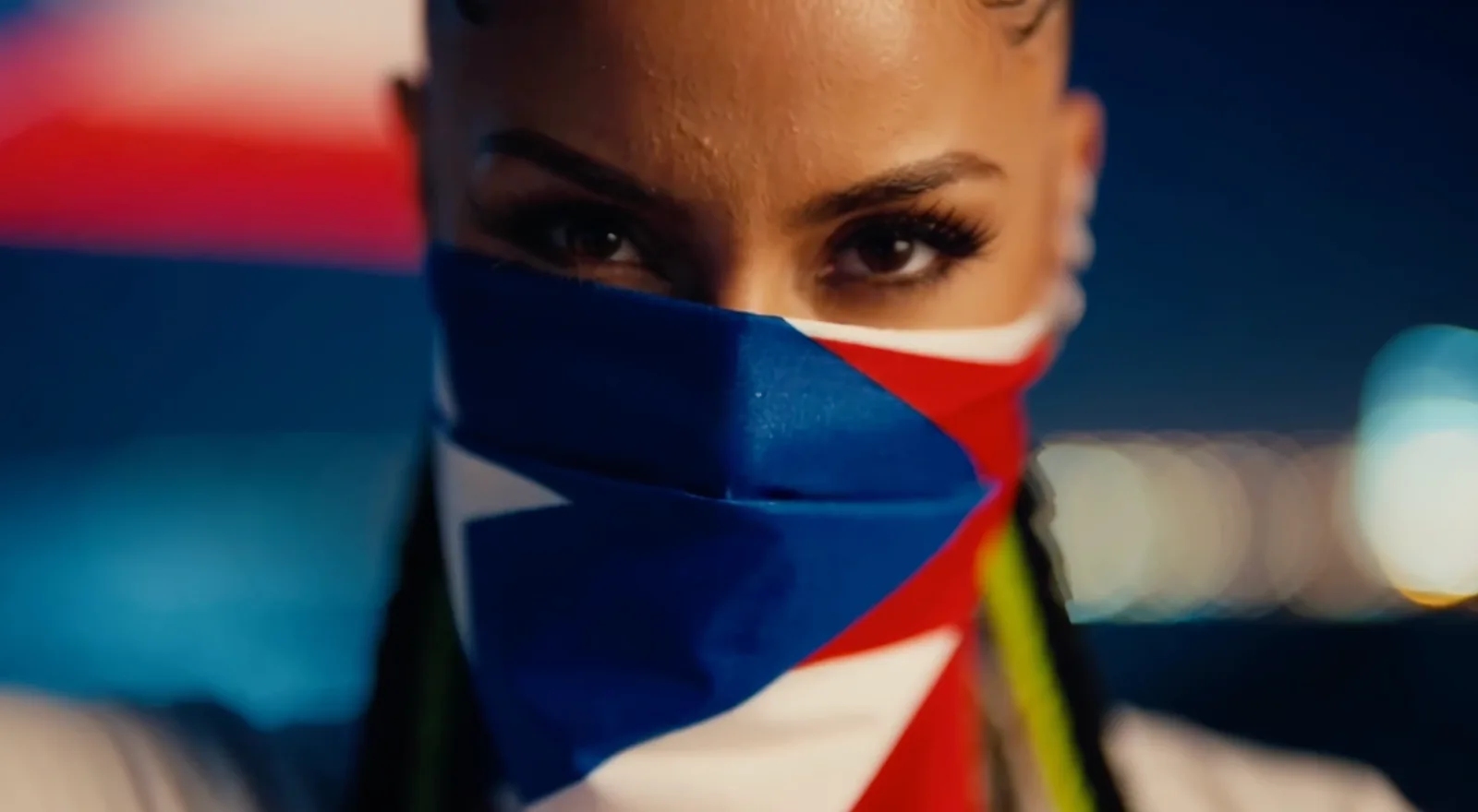 SUEZ3 with Puerto Rican flag over part of her face in the No Passport video