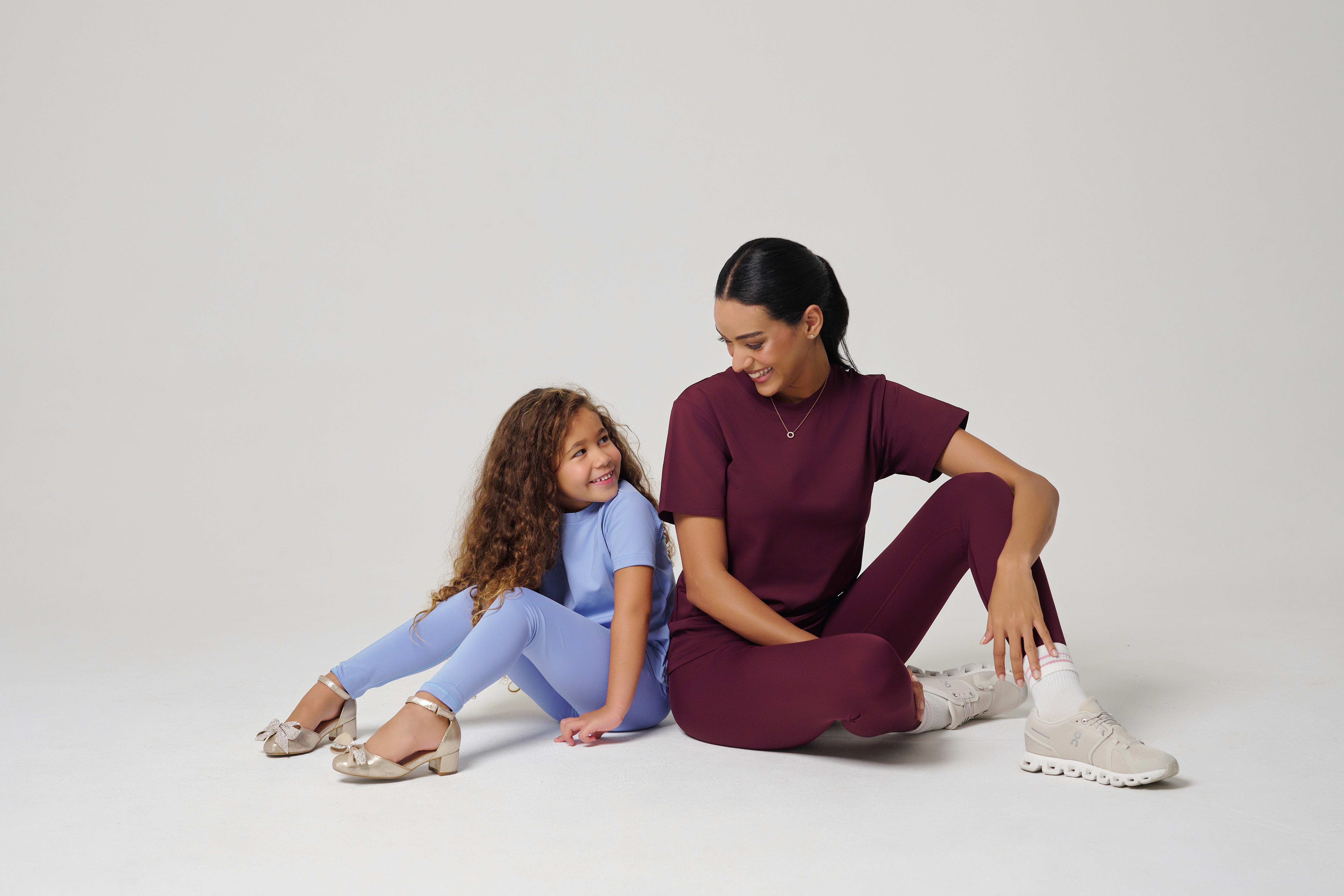People playing soccer on a rooftop court surrounded by city buildings
