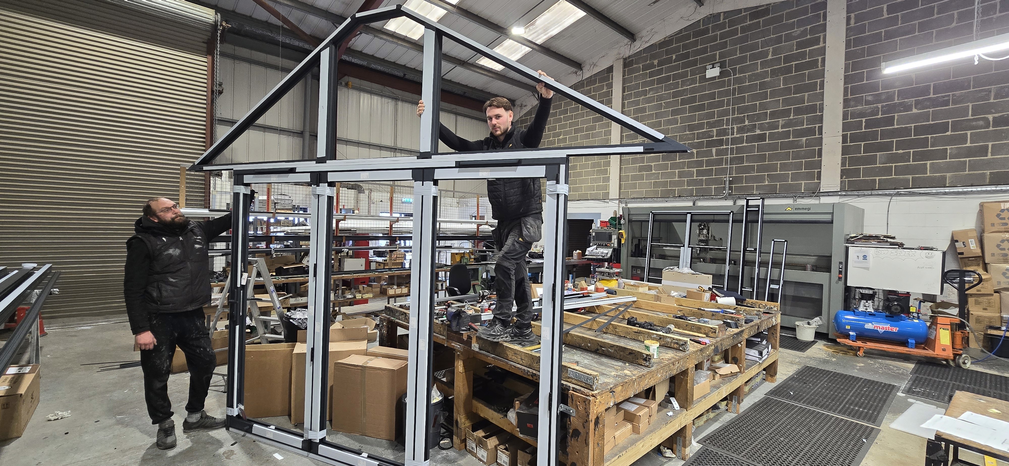 A GXG Aluminium fabricator lifting a finished gable frame in the Marden factory