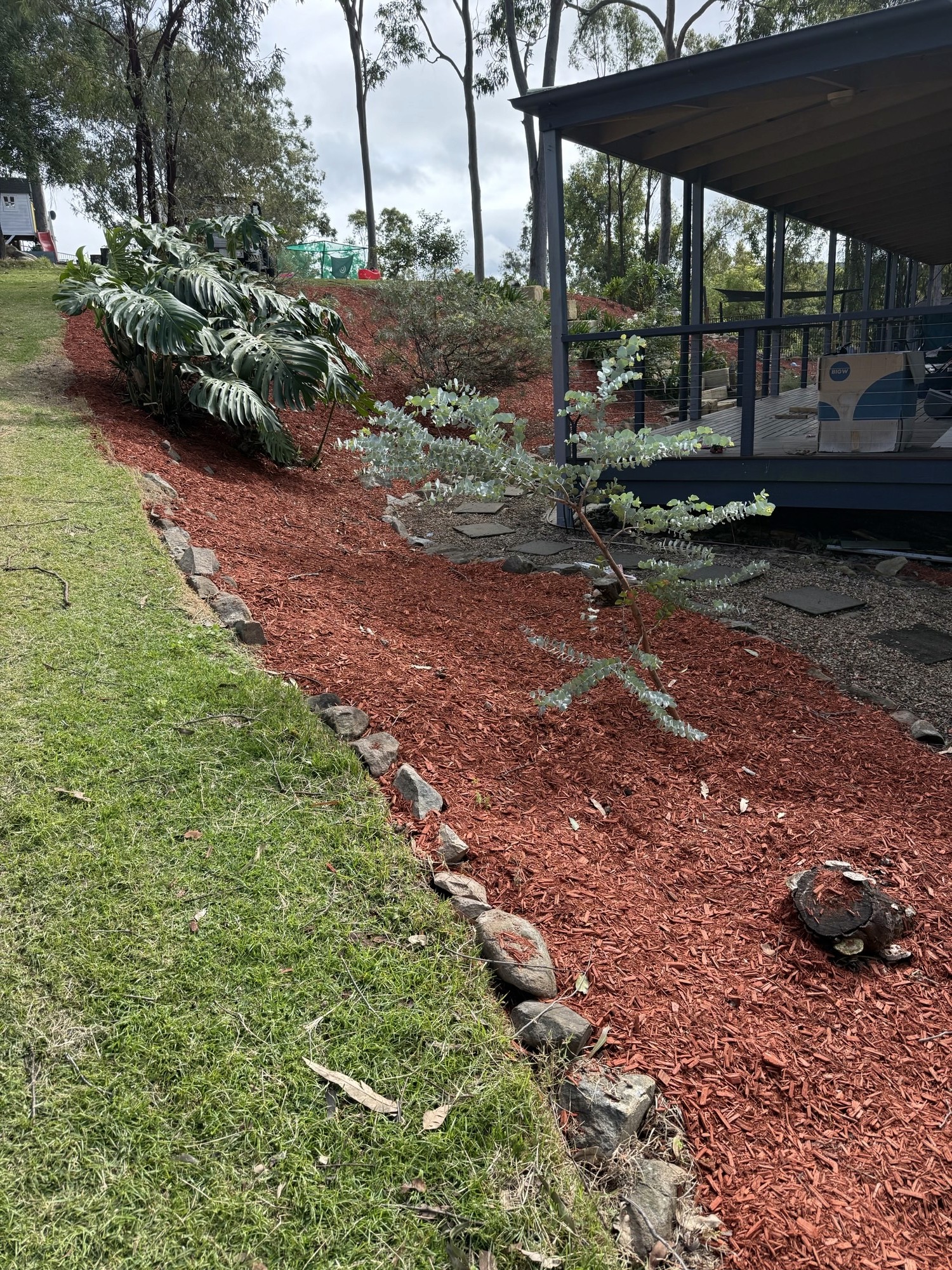 Garden mulching and tropical planting installation with clean edging Gold Coast by Hepburn Property Maintenance