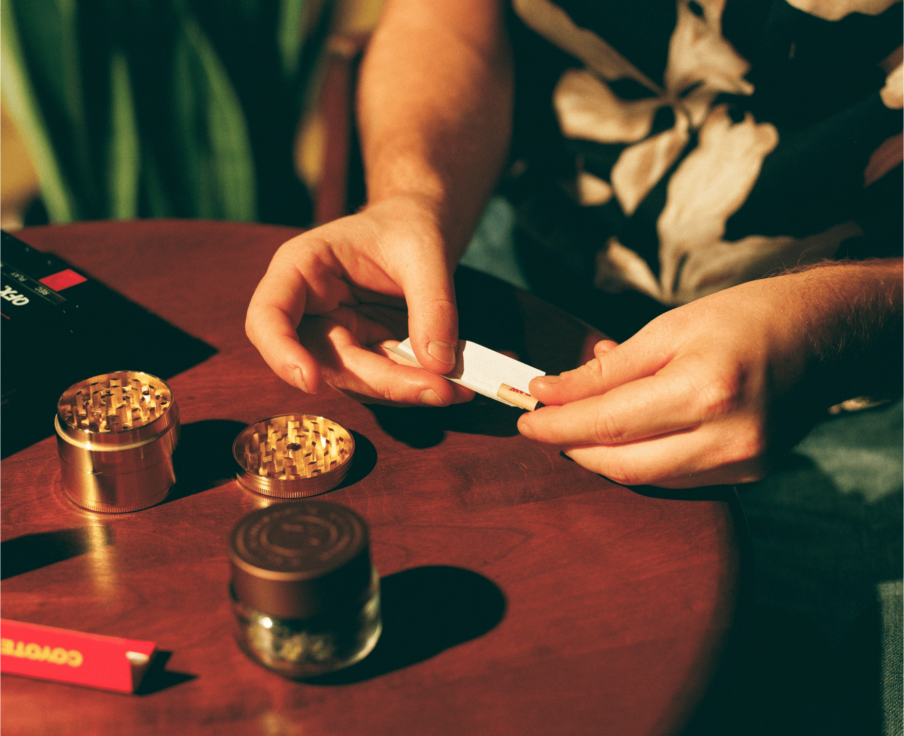 A hand lifting the first slice of a pizza on a marble table