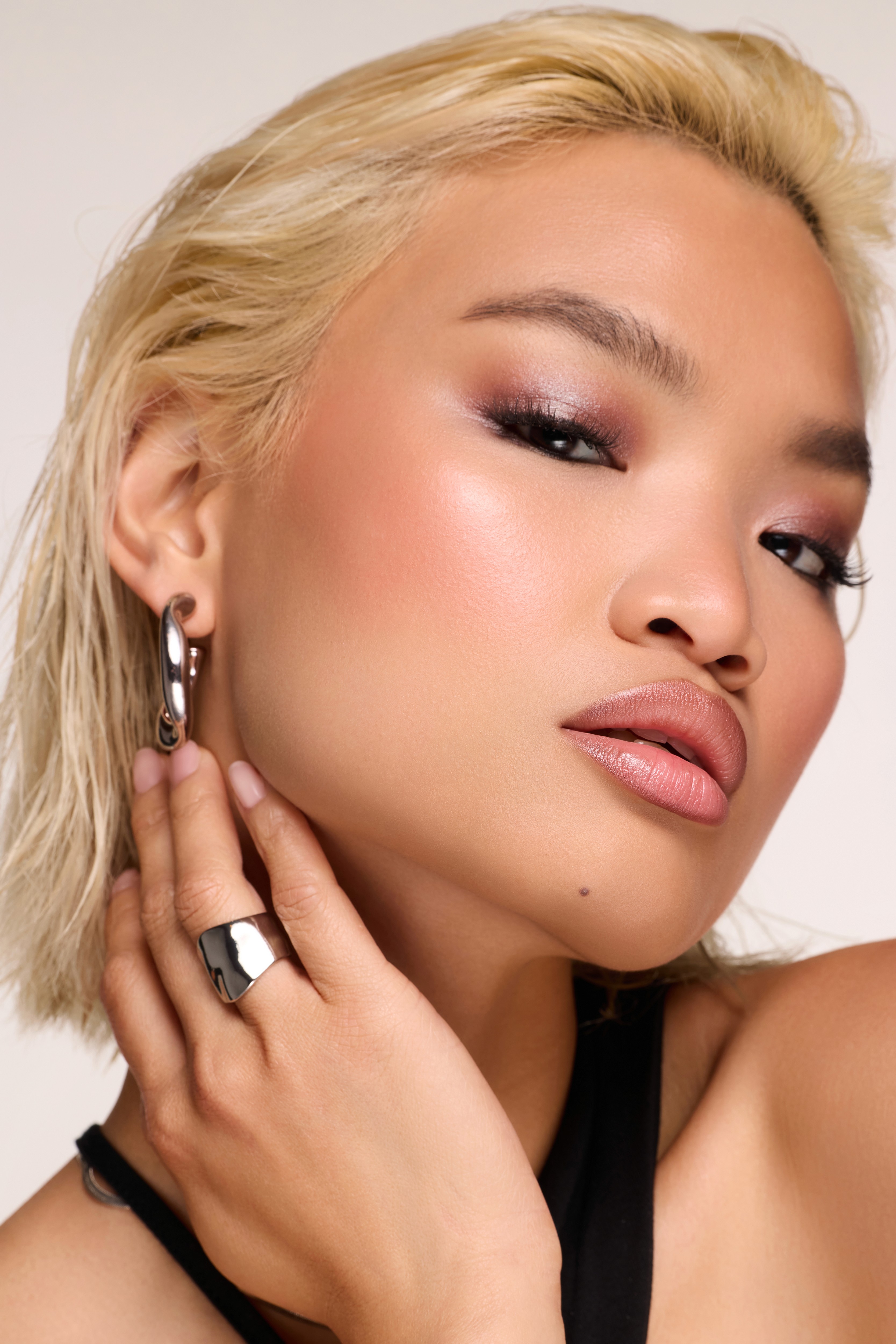 close up beauty image of woman with soft glam clean makeup in clean bright lighting