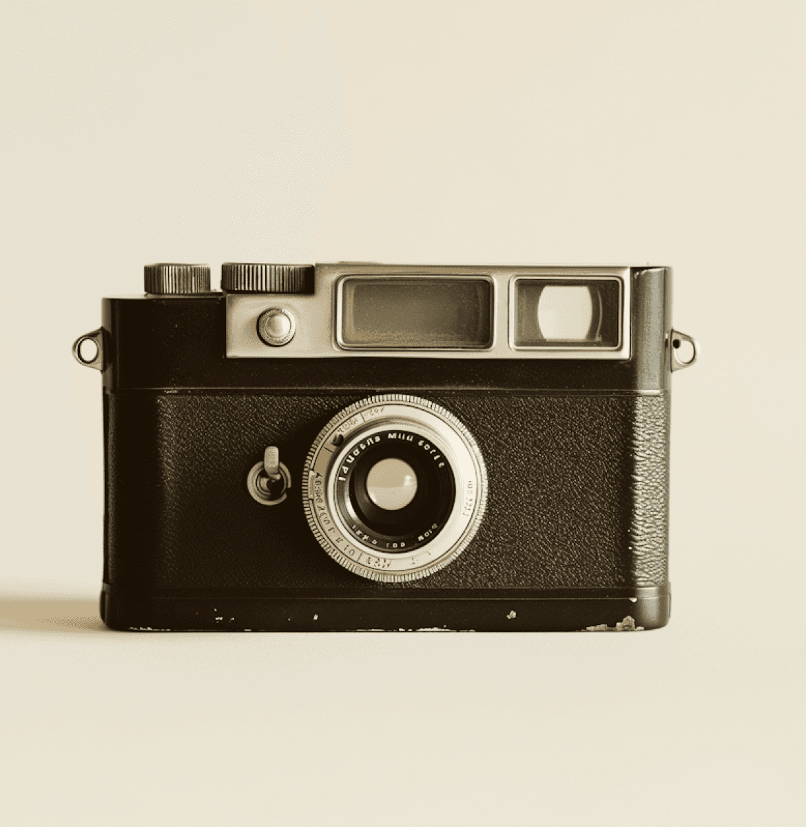 A vintage black camera with a manual lens, viewfinder, and textured grip.\