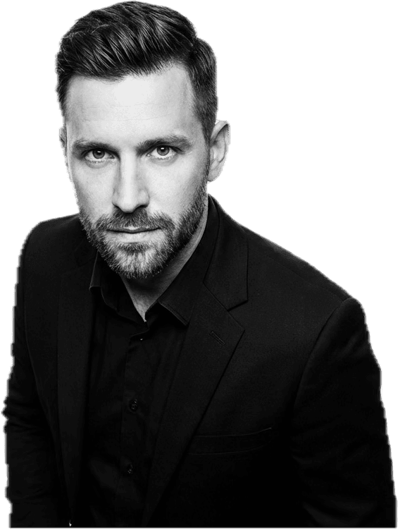 Professional woman in a suit standing in an office setting.