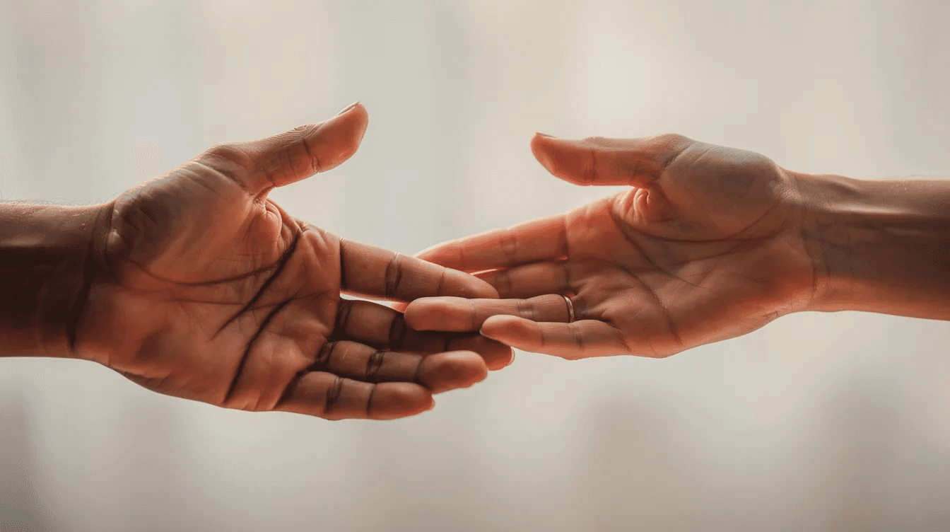 The image depicts hands reaching out to each other in a gesture of giving, symbolizing support and generosity among family members. This act of kindness can be part of tax-efficient gifting strategies, helping to transfer wealth while minimizing estate taxes and ensuring financial security for loved ones.