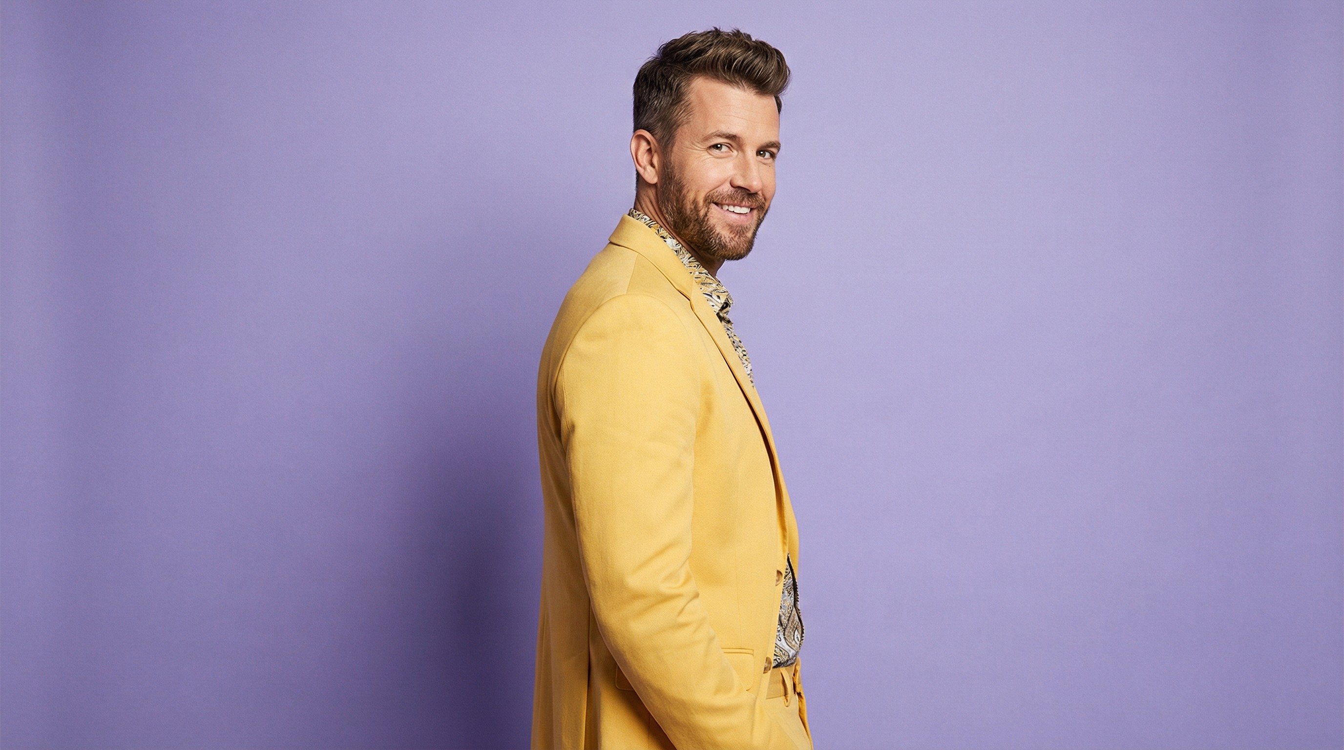 Close-up of lush, dark green leaves, some glossy and wet, against a muted background.