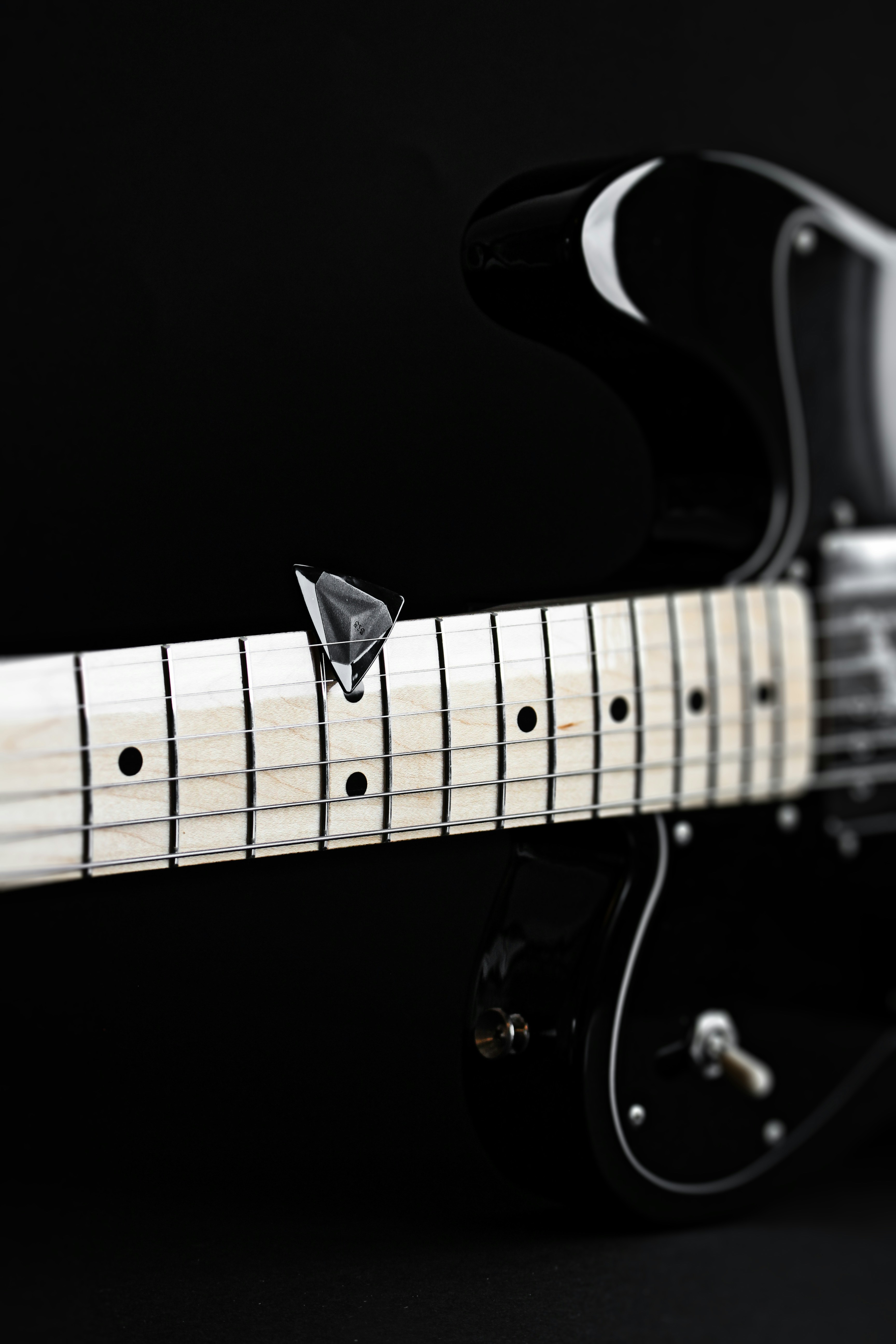 a close up of a black and white guitar
