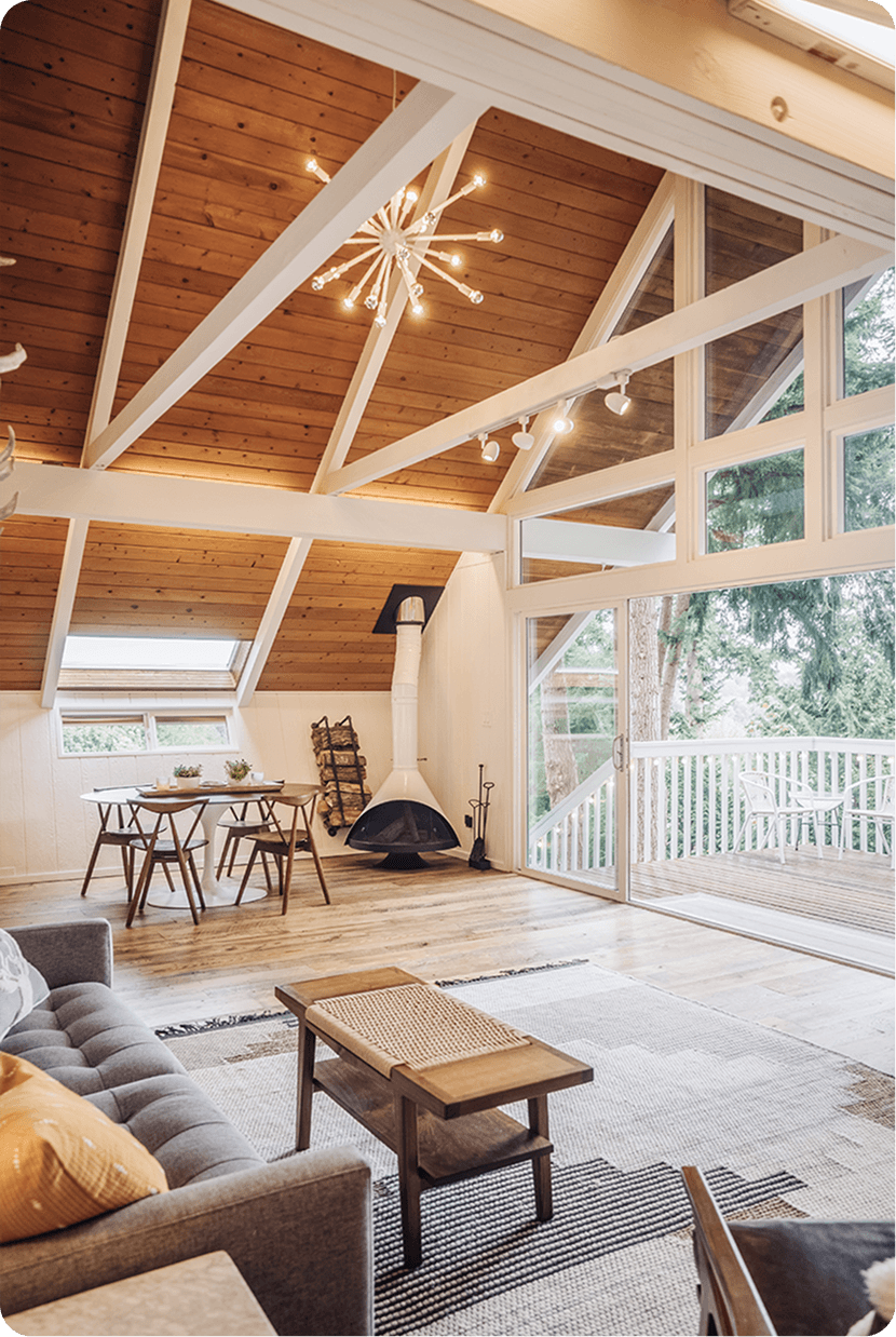 Modern marble shower featuring large format tiles, brass rainfall showerhead, handheld sprayer, and built-in seating bench
