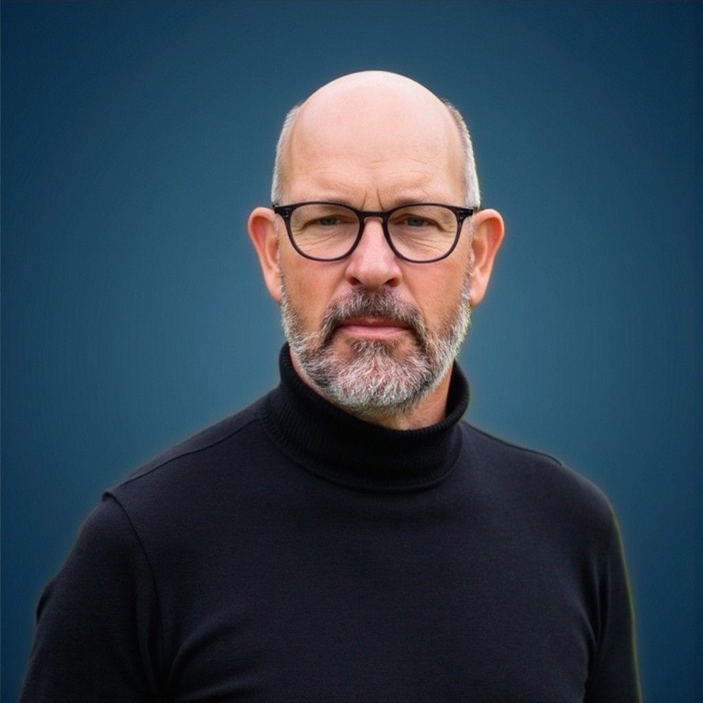 Portrait of a person in a pink sweater against a light background