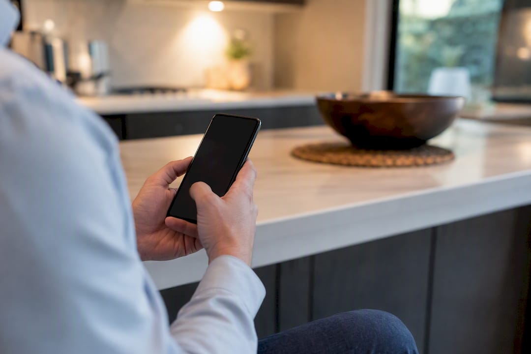 Hand texting on smartphone representing real estate lead response
