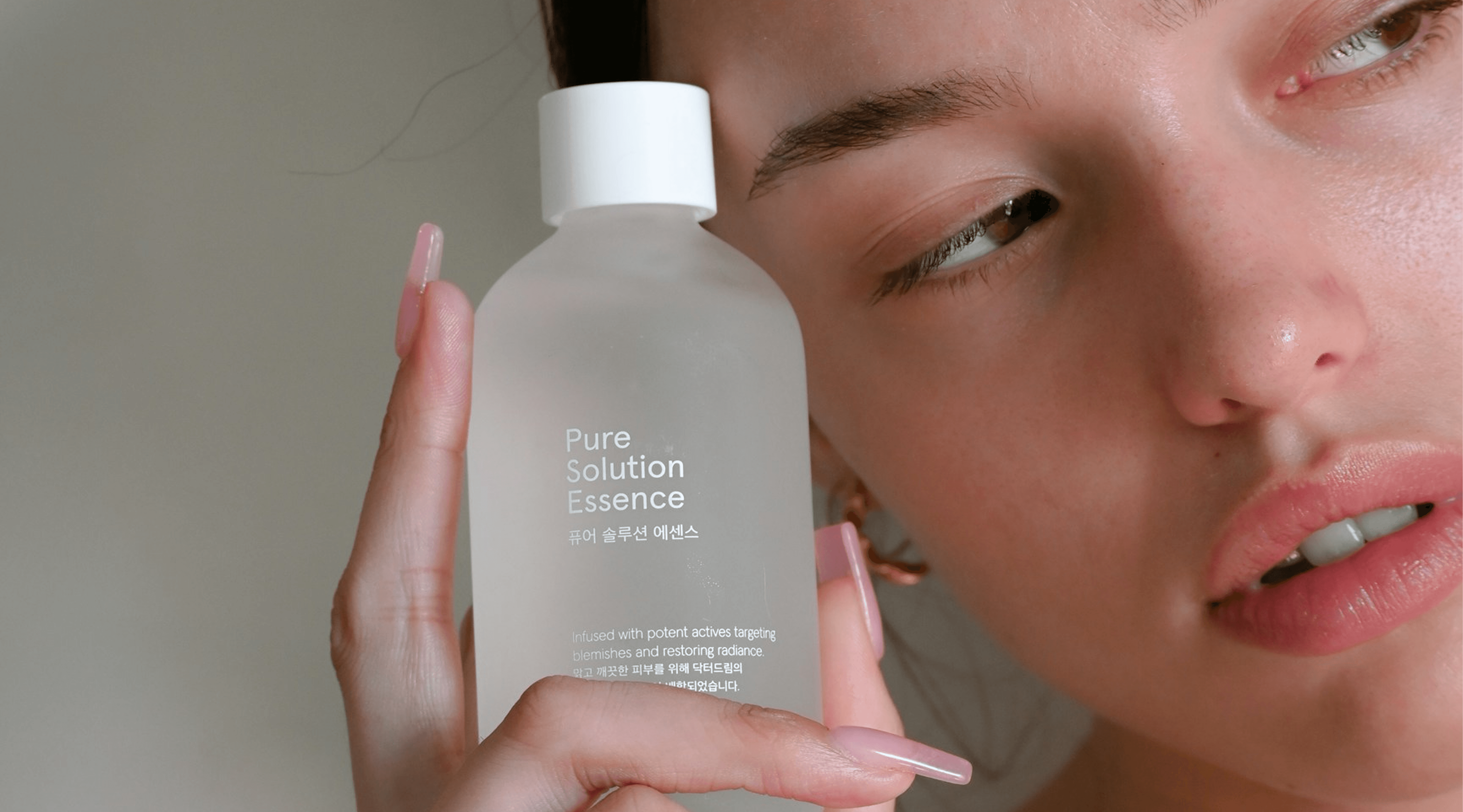 A woman holding a bottle