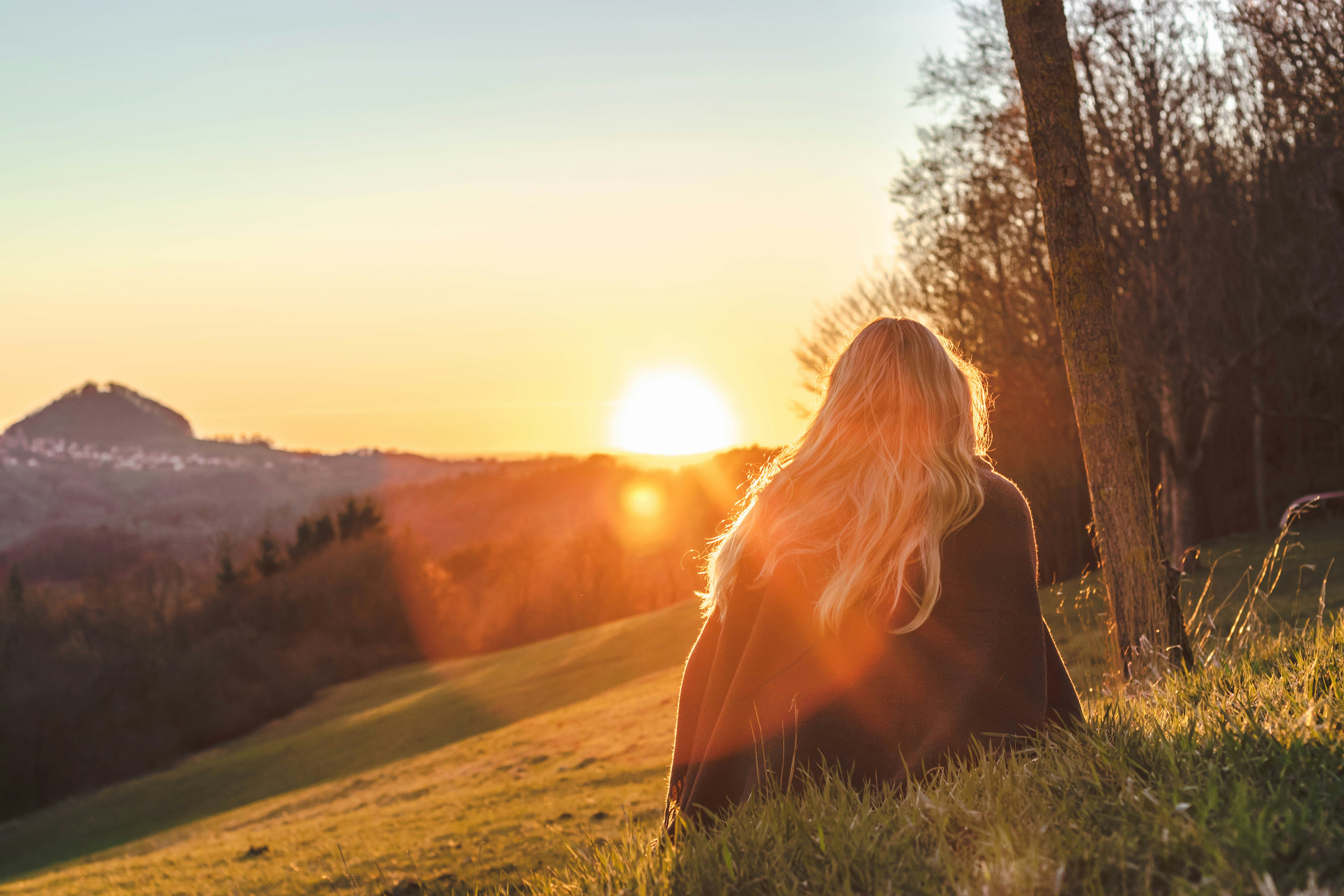 person sitting in sunlight - Best Time of Day to Get Vitamin D From the Sun 