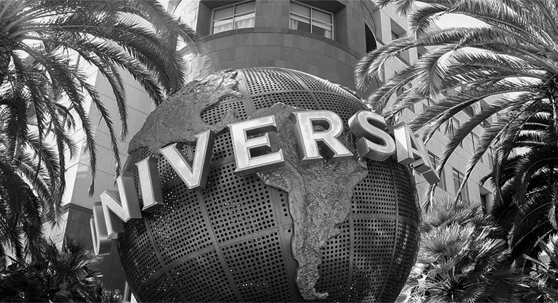 Photo of Universal logo sculpture surrounded by palm trees