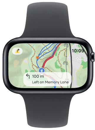 A smartwatch screen showing a trail map with an alert icon and directions reading ‘100 m — Left on Memory Lane.’