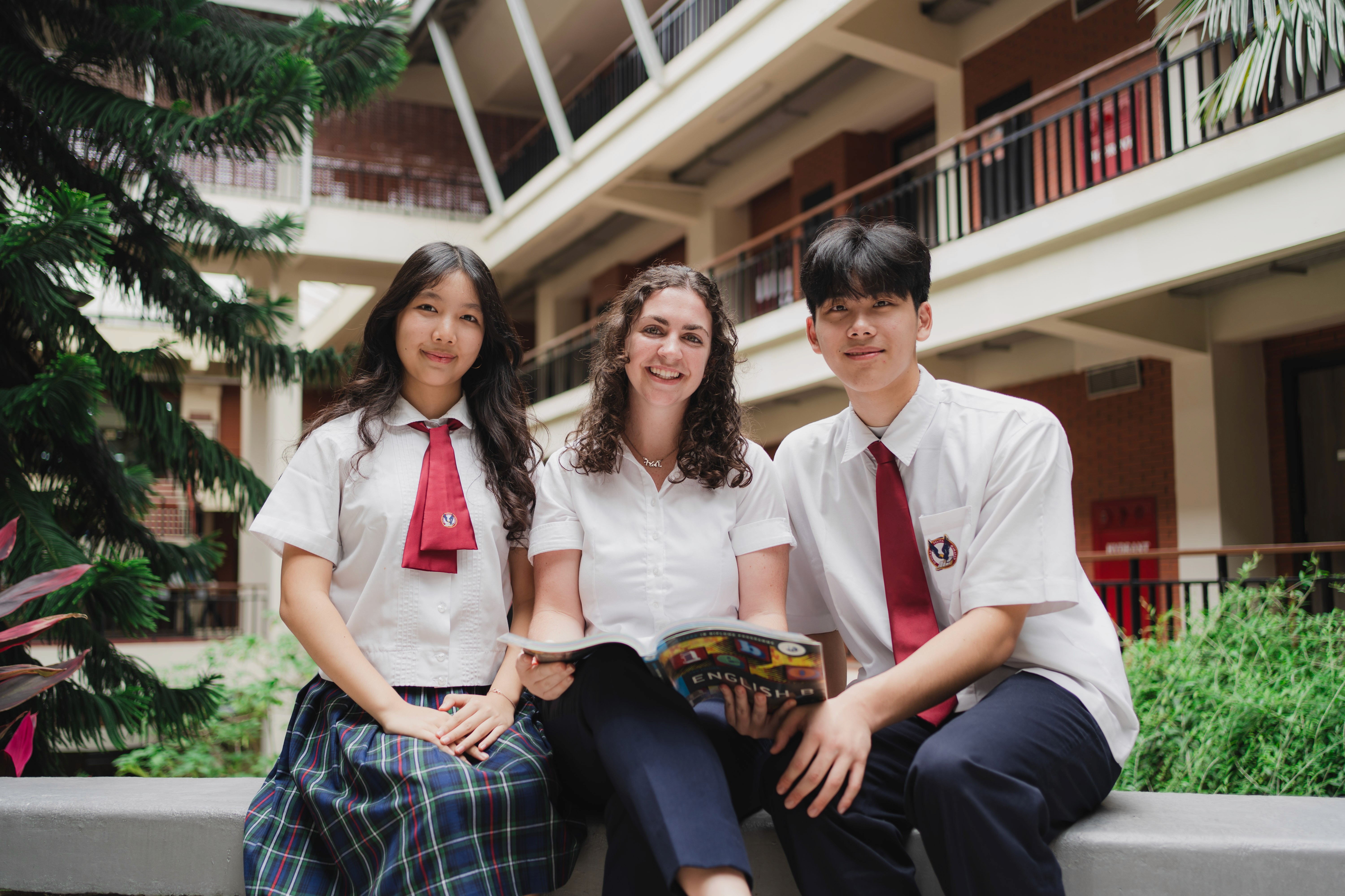 woman reading book while sitting on chair