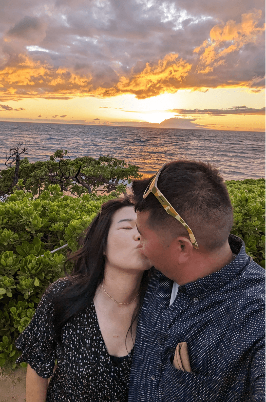 A woman with long blonde hair, in a brown top and jeans, walks through a sunlit forest, holding someone's hand. The scene is warm and inviting.