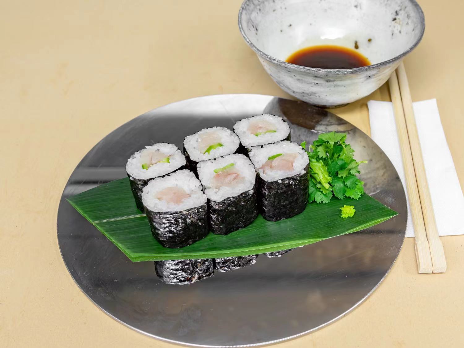 A close-up of Sushi 35 West’s signature Toro Rolls, featuring thick slices of buttery, melt-in-your-mouth tuna rolled with perfectly seasoned sushi rice and nori. The rolls are elegantly plated, garnished with a touch of microgreens and wasabi for a pop of color.