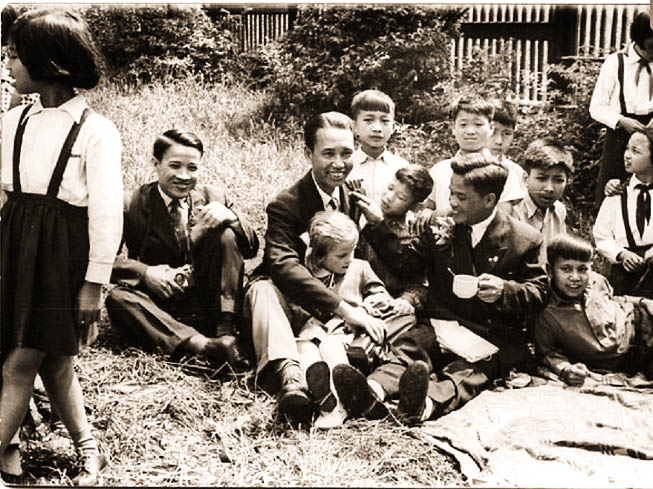 an old picture of a young vietnamese children sitting outside in the czech republic