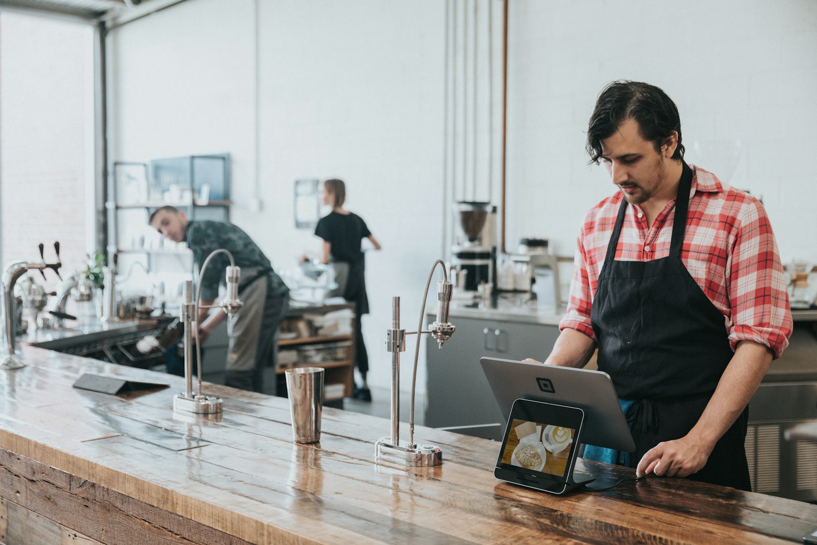 Restaurant operator using a tablet at the counter