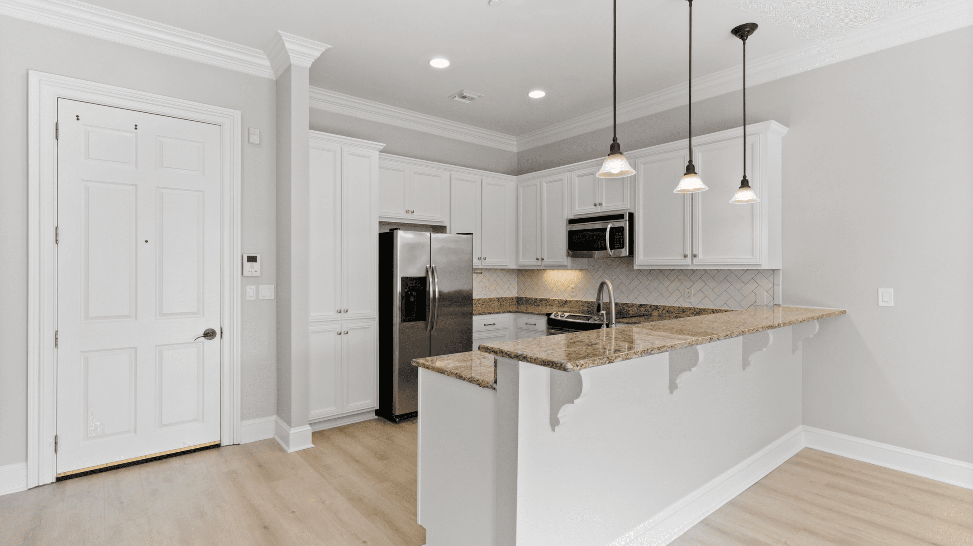 Modern, maintenance-free kitchen at The Gateway Village with luxury granite finishes and open design for easy living.