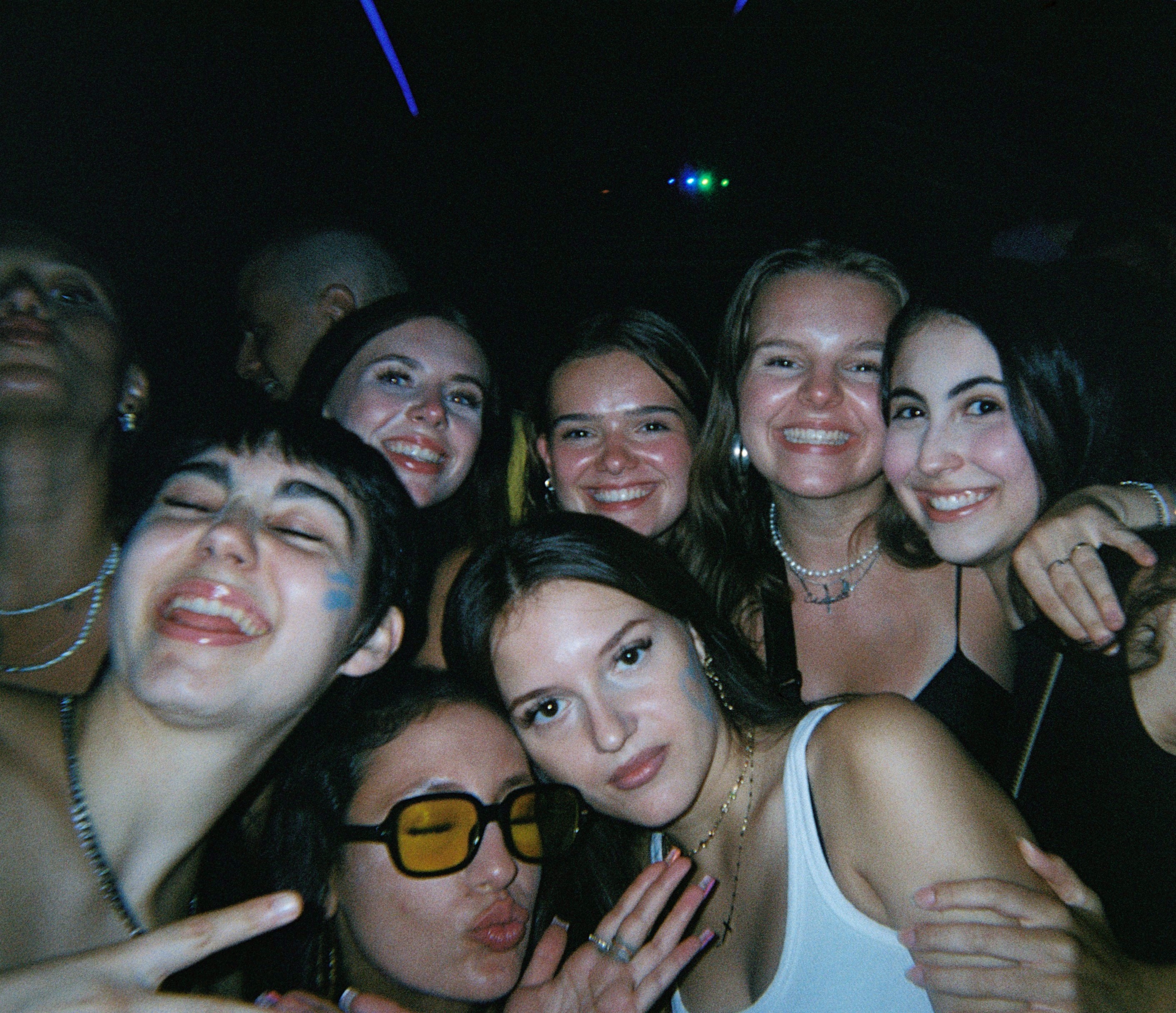 Travelers from different countries talking and laughing together in a lively bar in Nice at night, creating a social and welcoming atmosphere.
