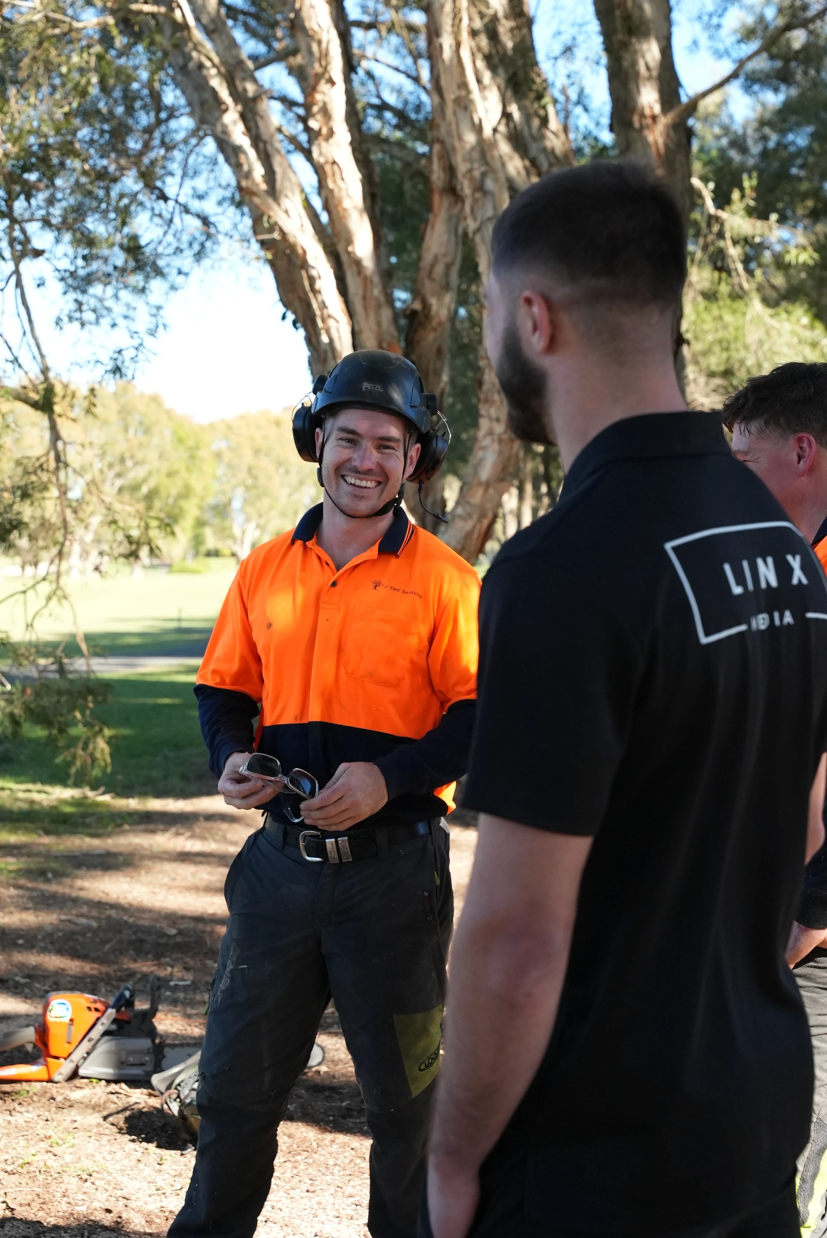 Two GC Tree Solutions arborists discussing a job on site