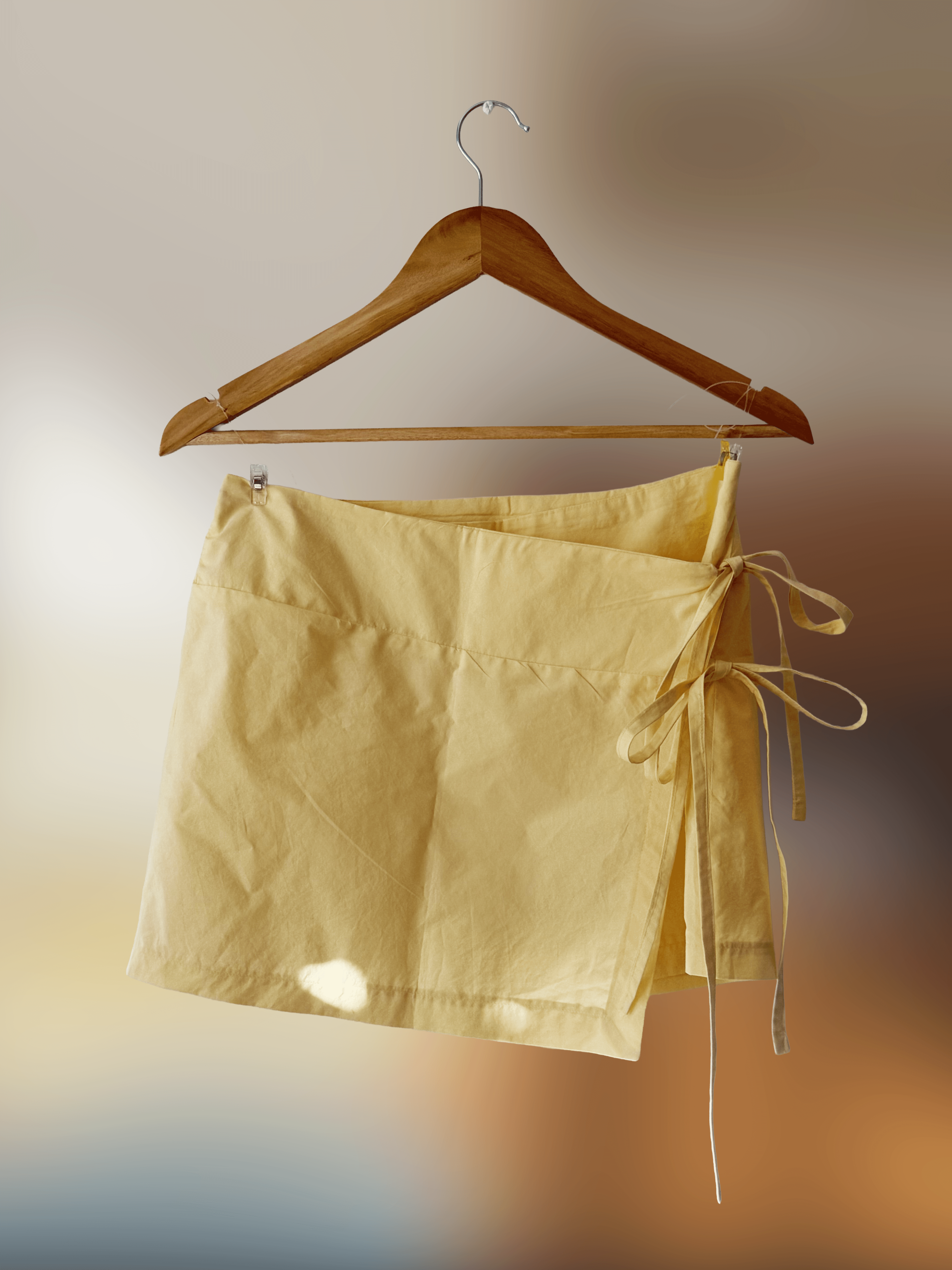 front view of a short yellow wrap skirt