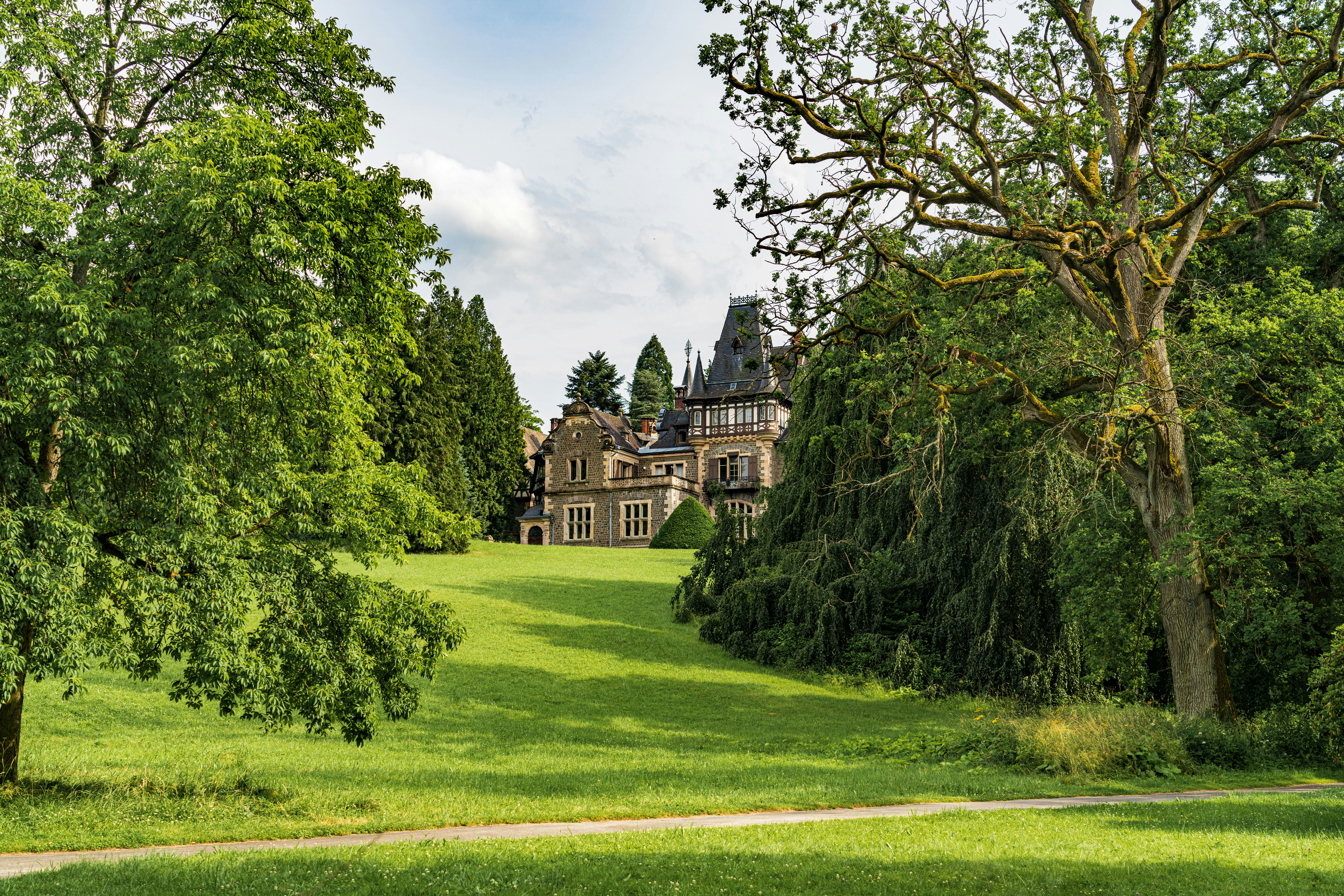 A royal garden surrounding a traditional-style building.