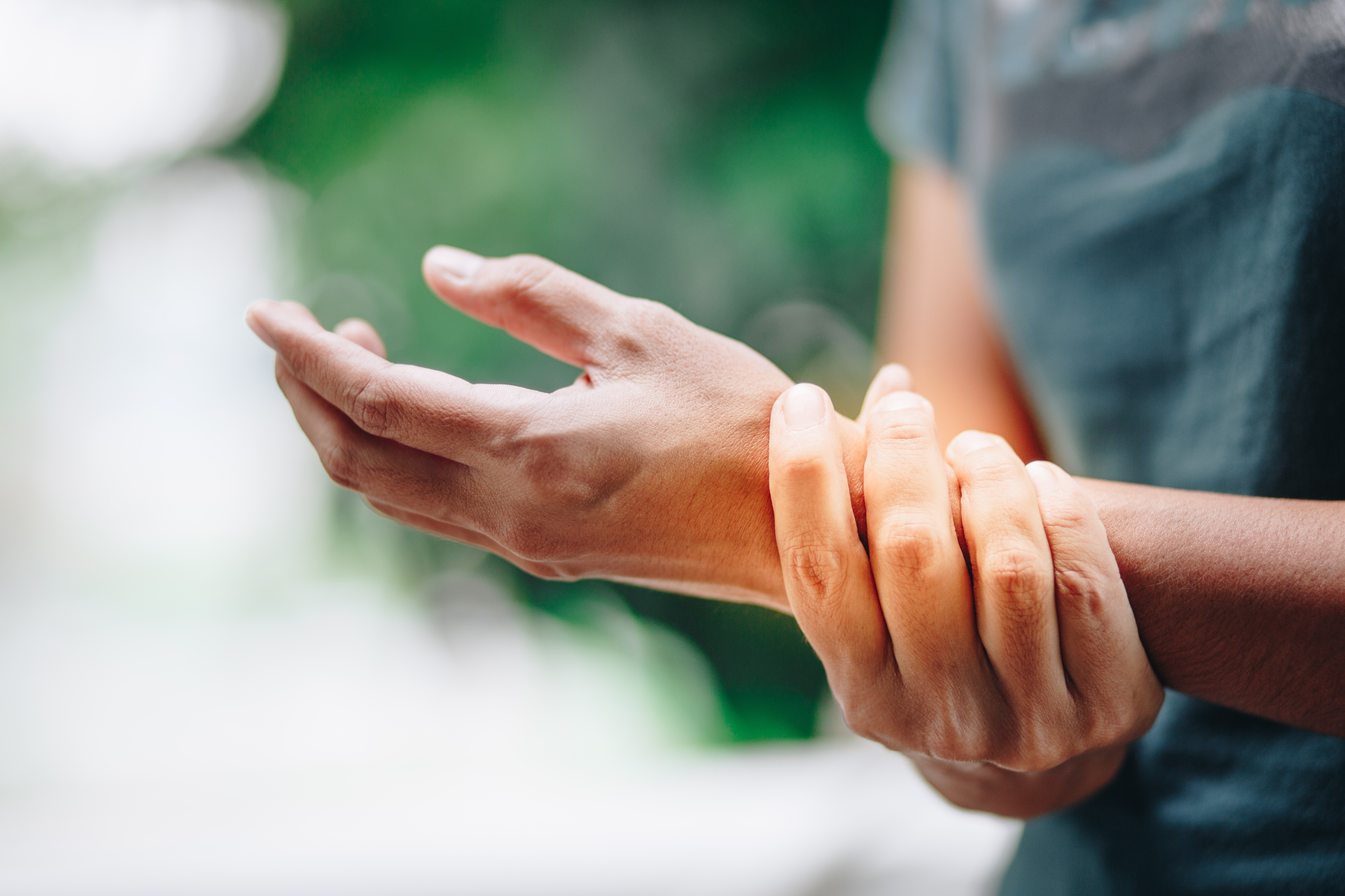 man holding wrist in pain