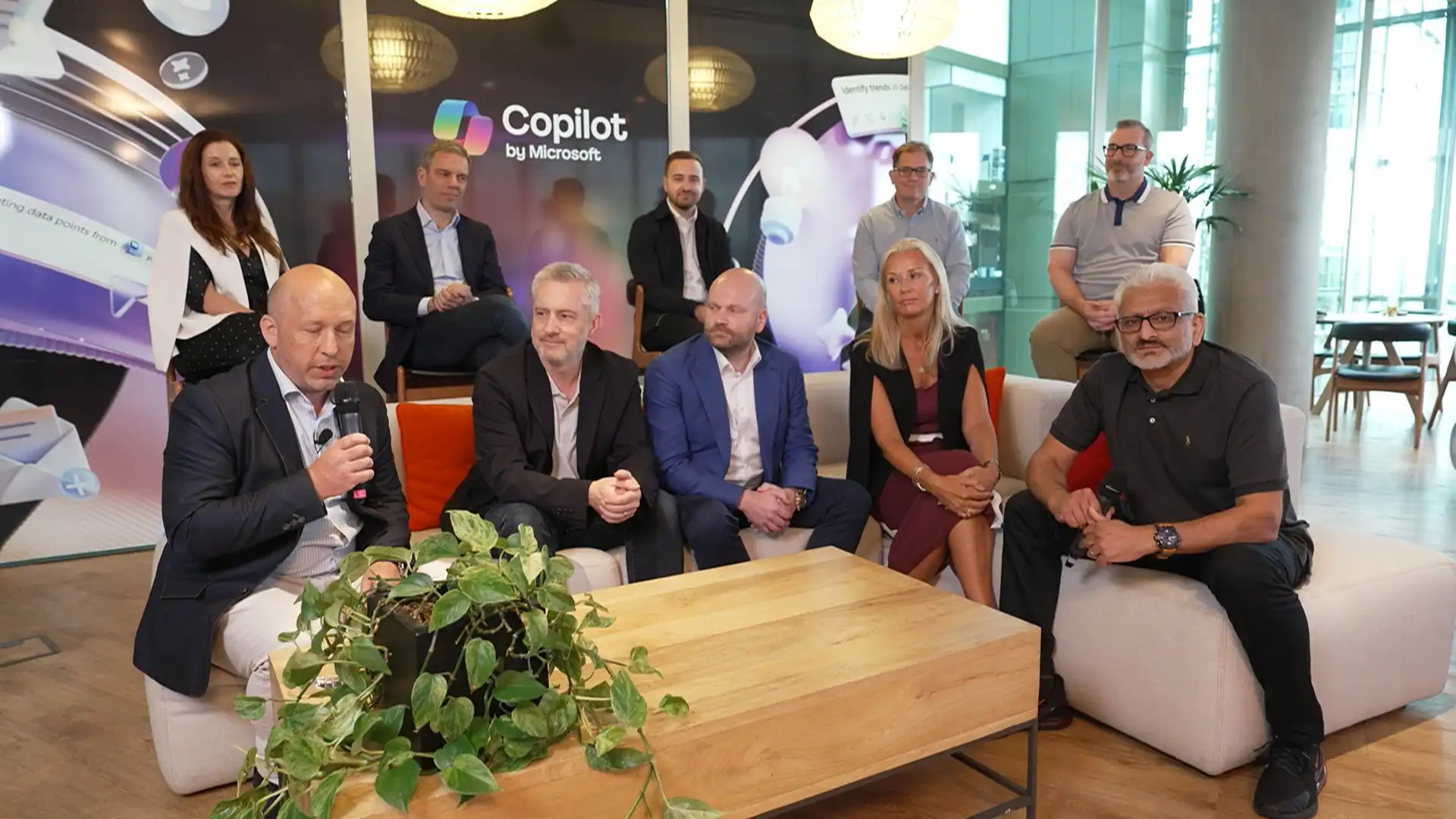 Panel discussion featuring multiple contributors seated in a studio-style environment, focused on shared insights and discussion.