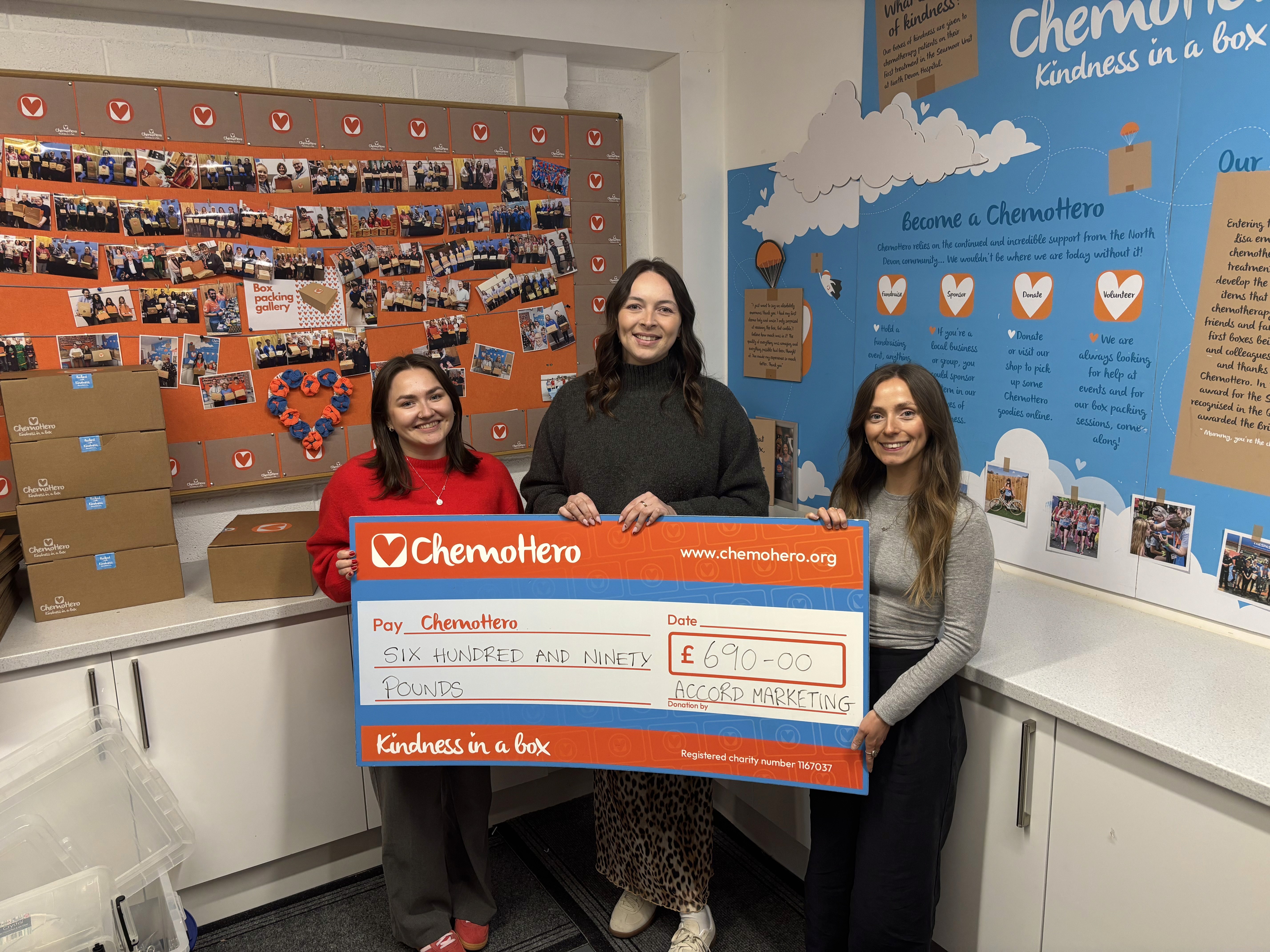Six people taking a selfie together with a bright outdoor setting behind them.